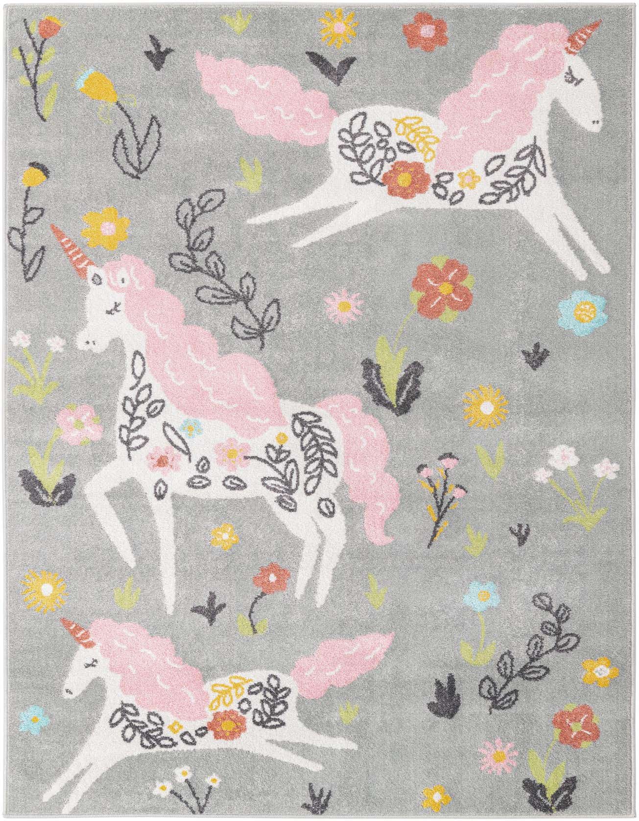 A rectangular gray rug featuring three white unicorns with pink manes and tails, surrounded by colorful flowers and foliage, ideal for a child's room.