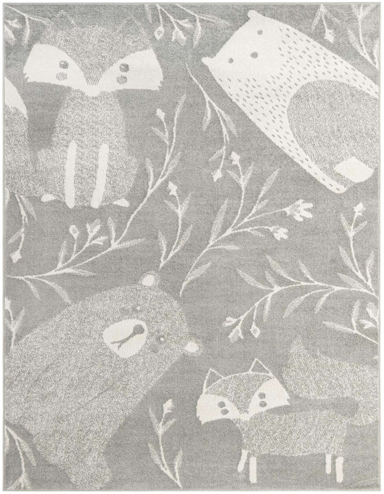 A 6x9 rectangular gray rug featuring a whimsical pattern of white woodland animals like foxes, bears, and hedgehogs, interspersed with delicate white branches and leaves.