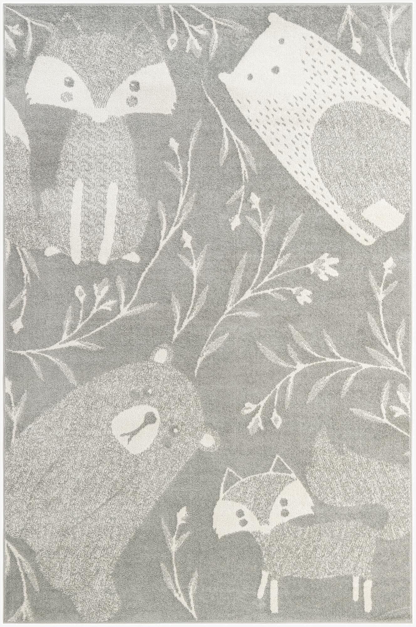 A 6x9 rectangular gray rug featuring a whimsical pattern of white woodland animals like foxes, bears, and hedgehogs, interspersed with delicate white branches and leaves.