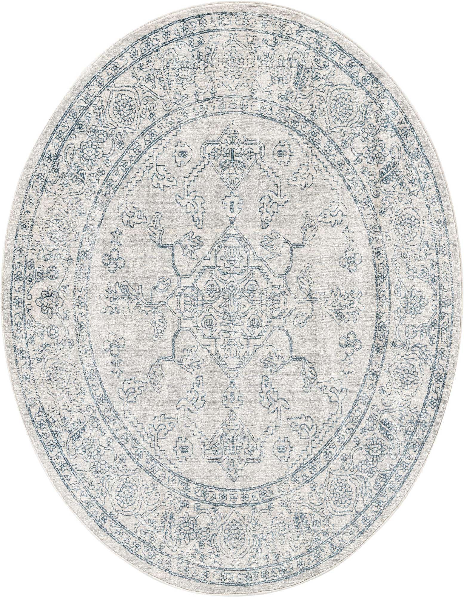 A 5' 3 round gray area rug with a faded blue traditional medallion and tribal pattern, suitable for indoor spaces.