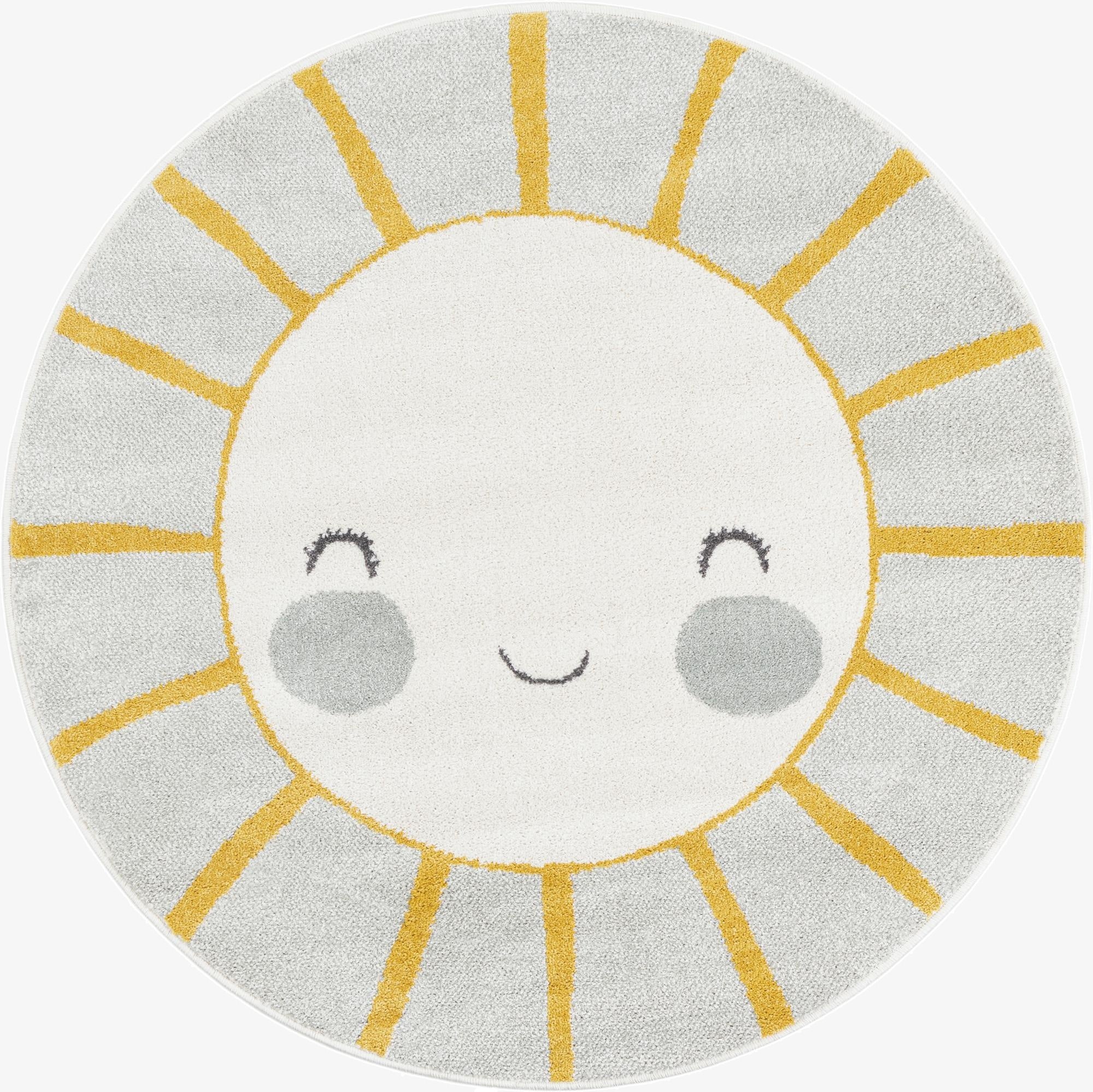 A round gray and yellow rug featuring a smiling sun face with white center, gray cheeks, and yellow rays.