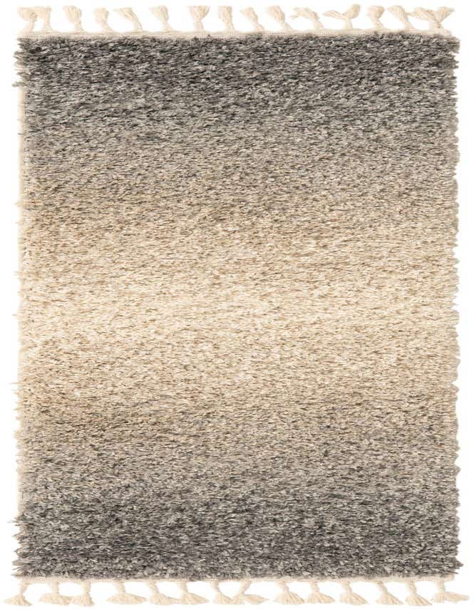 A 6 ft runner rug with a gray to light gray ombré shag pile and decorative cream tassels on both ends.