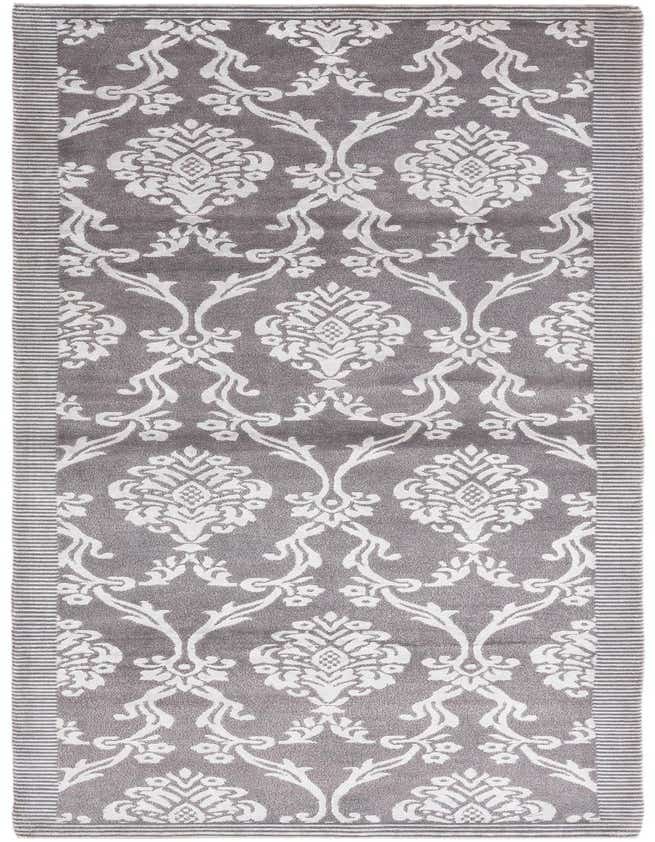 A 10 ft runner rug in shades of gray and silver, featuring a high pile and a modern oriental pattern with white damask-like motifs and striped borders.