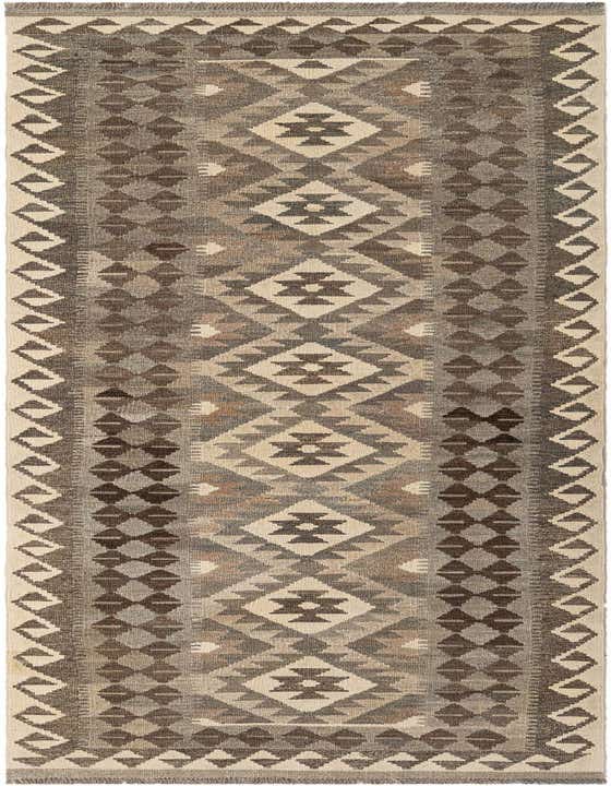 A 10 ft runner rug with a tribal geometric pattern in shades of gray, silver, and cream, suitable for a hallway.