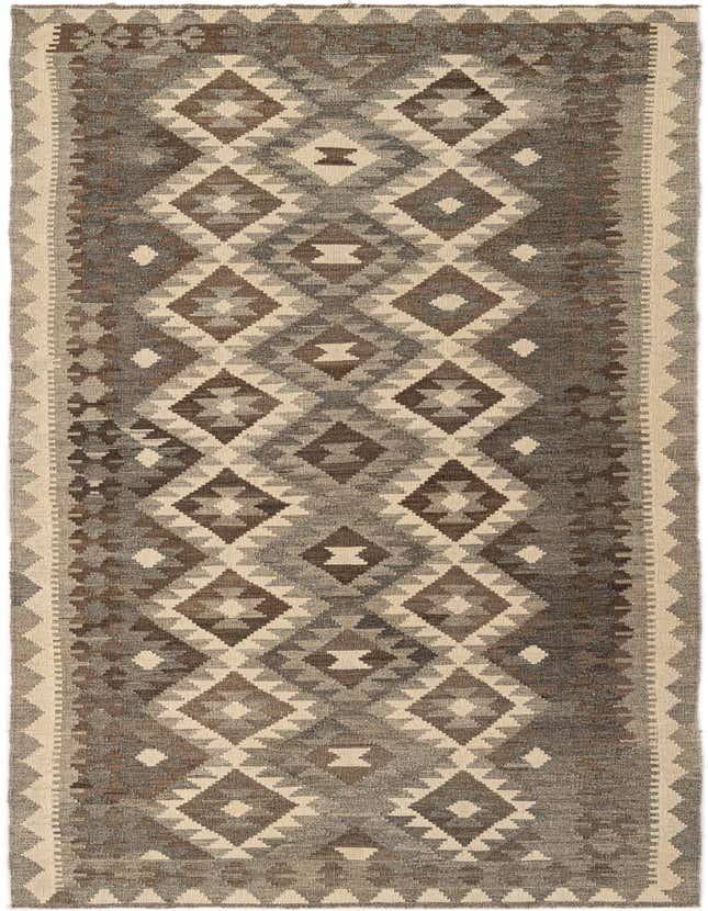 A 10 ft runner rug from the Kilim Maymana collection, featuring a tribal geometric pattern in varying shades of gray, silver, and cream.