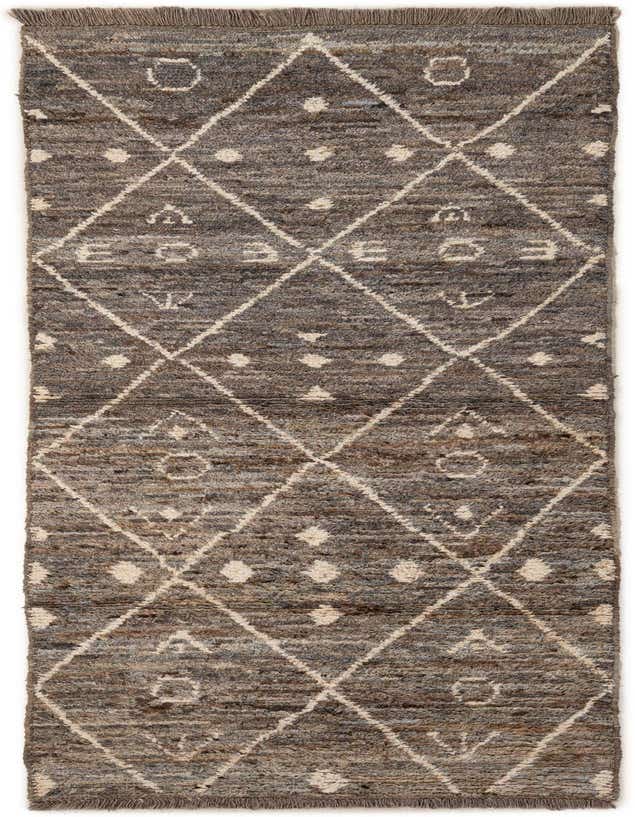 A 9 ft runner rug in shades of gray and silver, featuring a tribal diamond pattern and fringe.