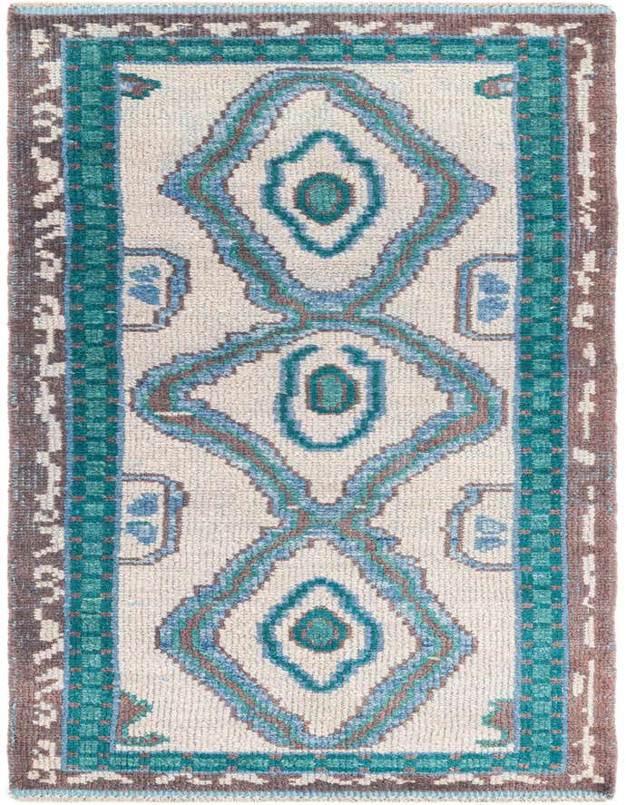A gray 8 ft runner rug with a tribal pattern in blue, teal, and brown, featuring a shag pile.