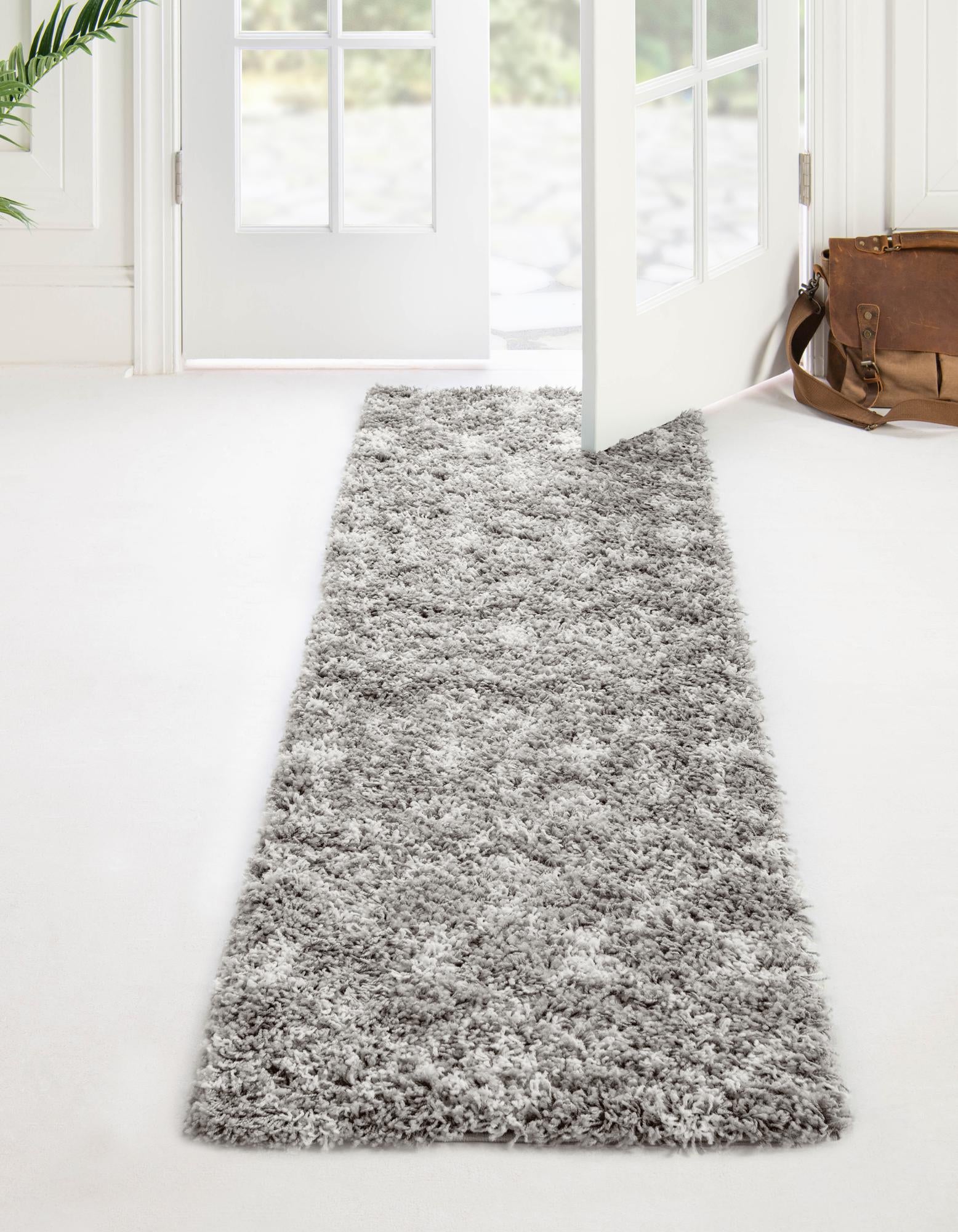 A 10 ft runner rug from the Moroccan Trellis Shag collection, featuring a soft gray and off-white tribal pattern.