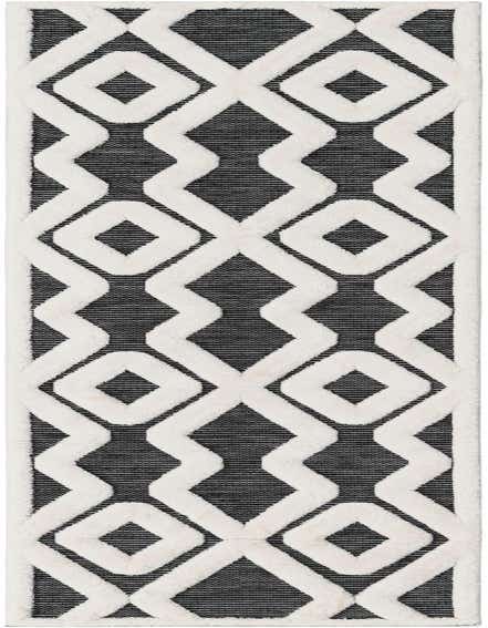 A 12 ft runner rug featuring a bold geometric pattern of raised white diamonds and zigzags on a textured gray background, ideal for a hallway.