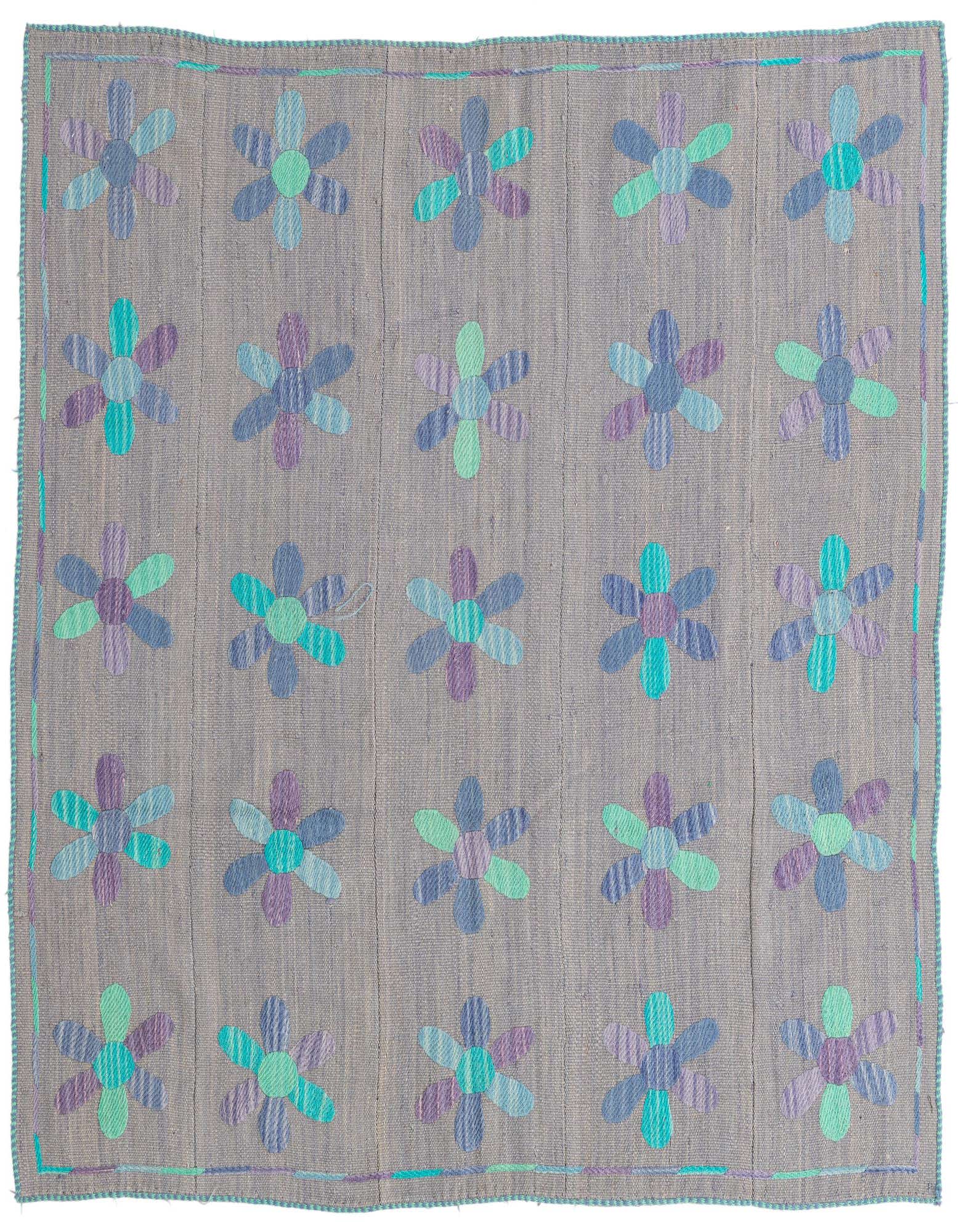 A 5' 4 x 5' 5 square gray flatweave wool rug with a repeating pattern of colorful tribal flowers in blue, purple, and teal.
