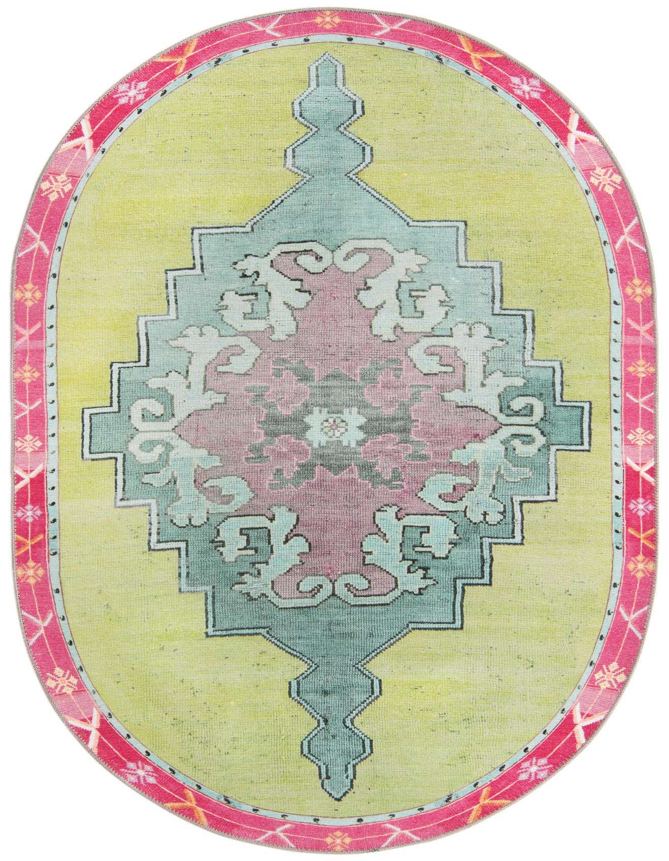 A 4'x6' oval green rug with a central vintage medallion in pink and teal, framed by a vibrant pink border.