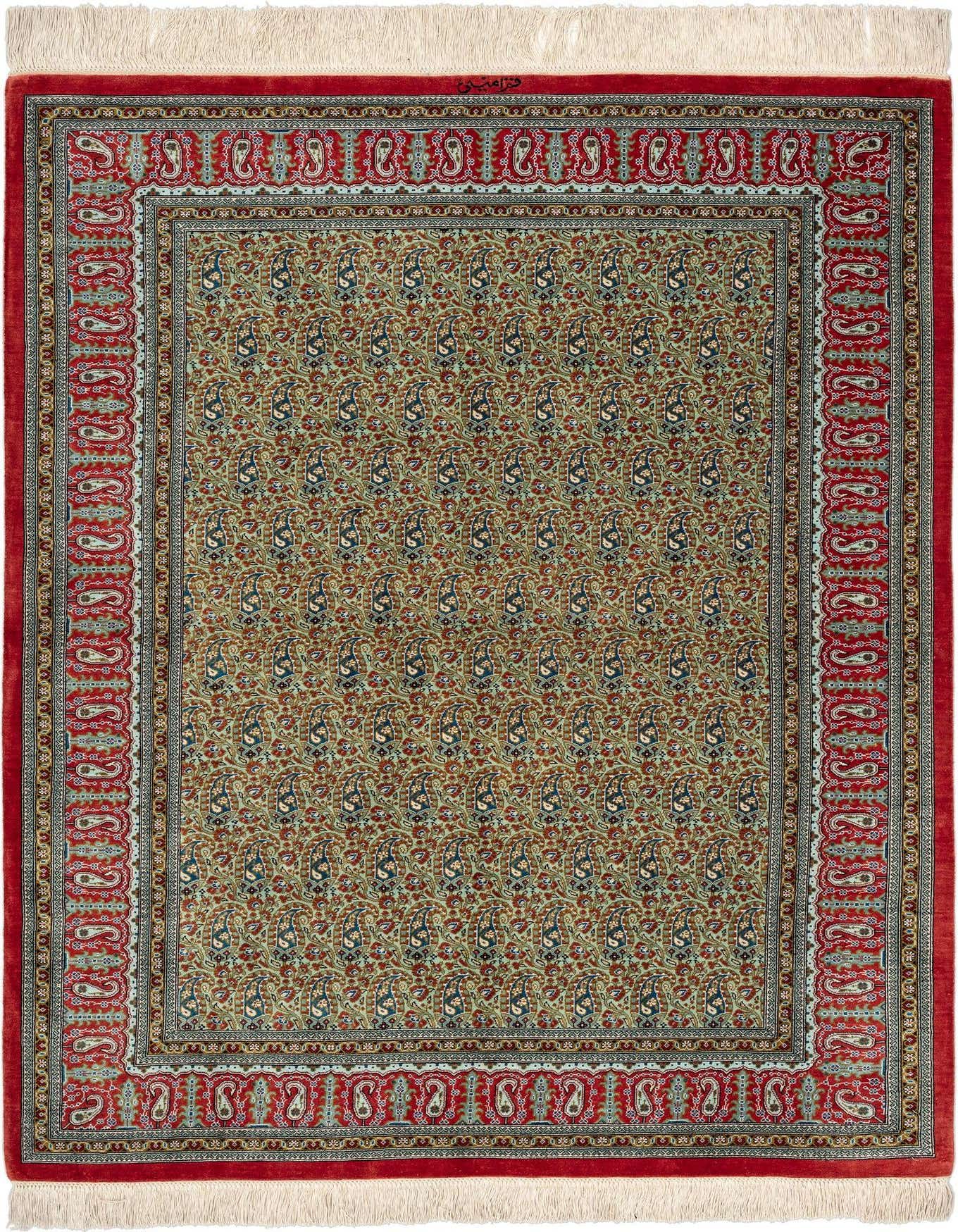 A 3x5 rectangular Ghom Silk Persian rug featuring a green field with intricate red and blue paisley patterns, bordered by a rich red frame with complementary designs, and finished with white fringes.