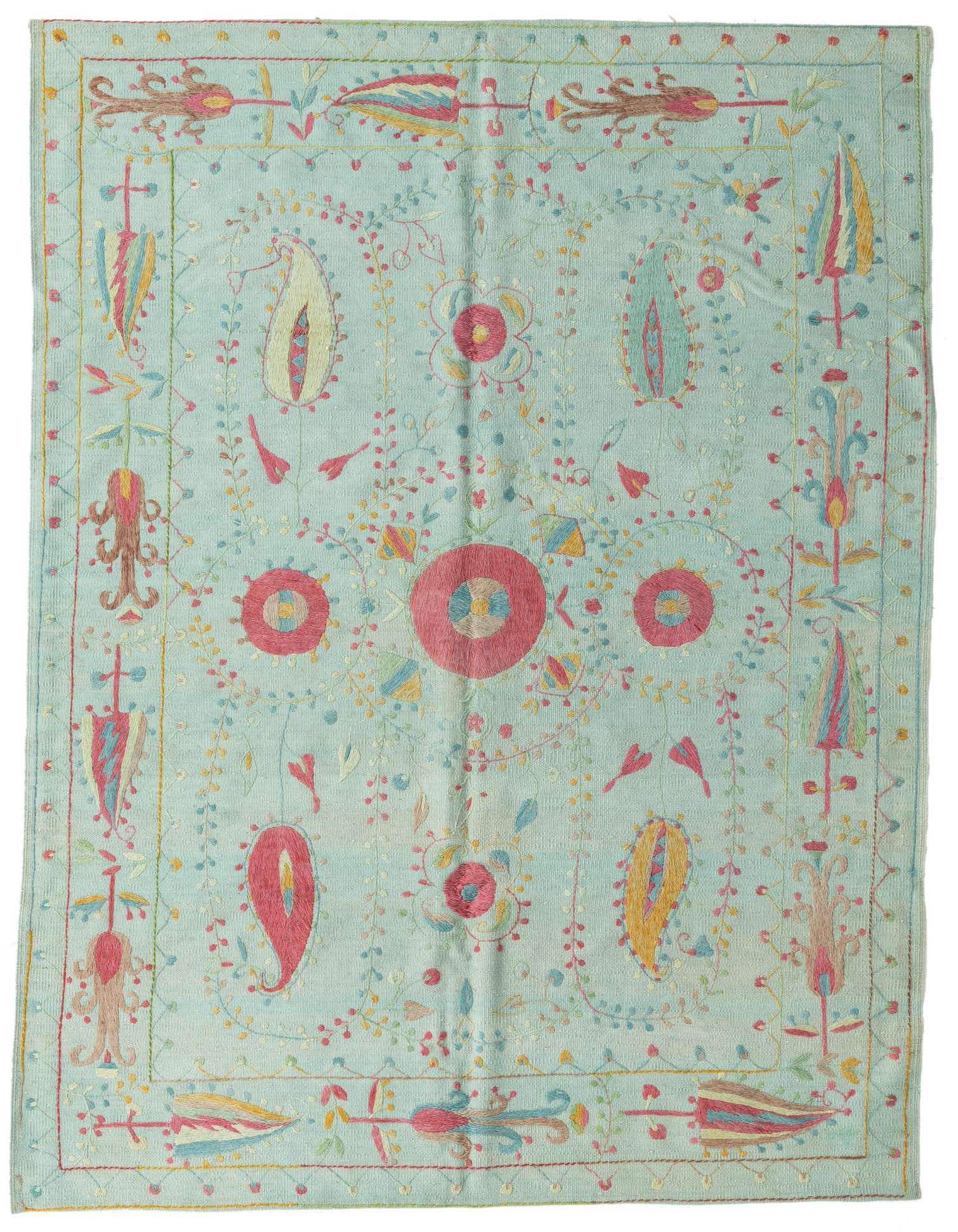 A 6x9 rectangular Kilim Suzani rug featuring a light green background with vibrant floral and paisley tribal patterns in pink, yellow, and blue.