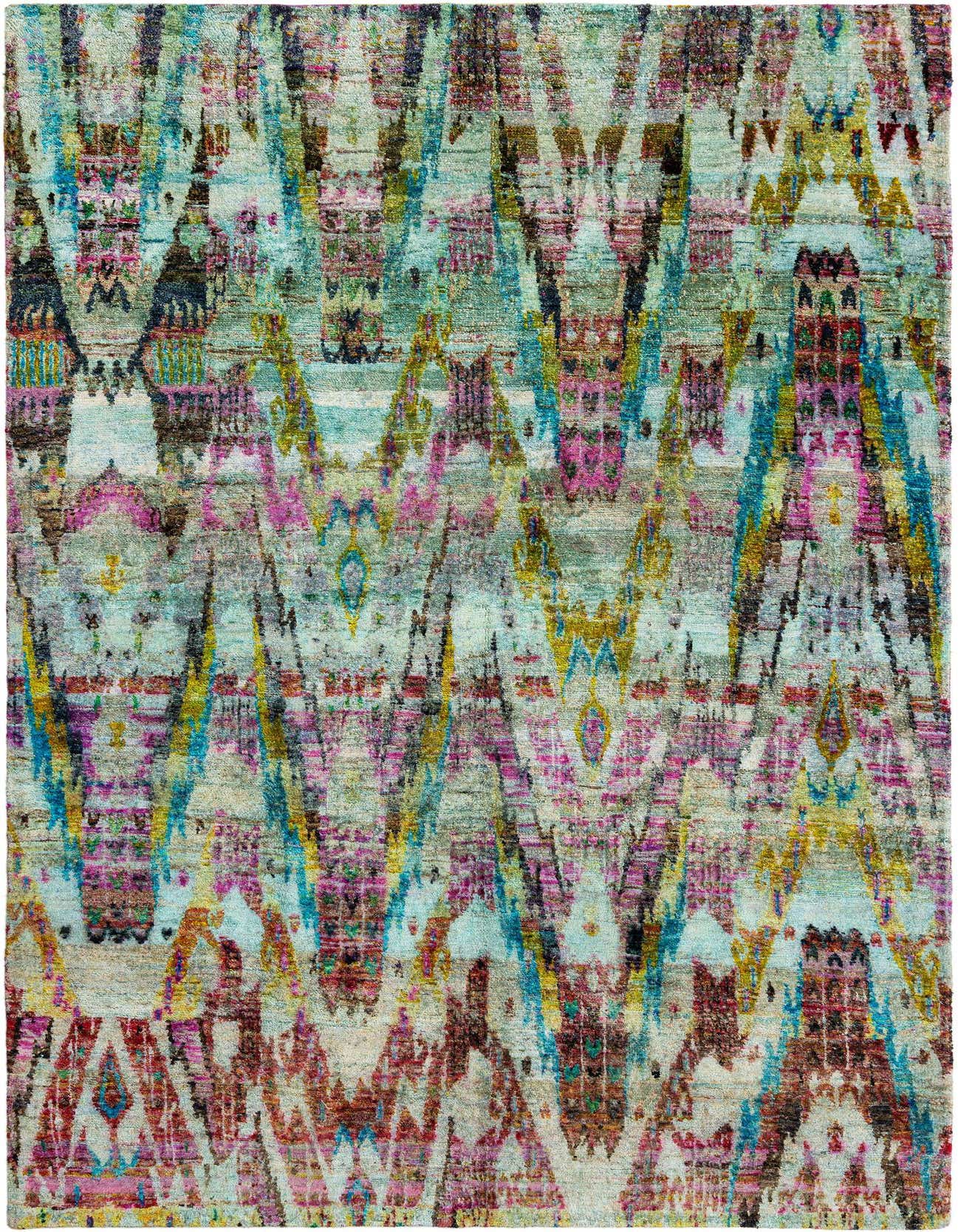 A rectangular handmade Kundan Persian rug featuring a vibrant, distressed ikat pattern in shades of green, pink, blue, and gold.