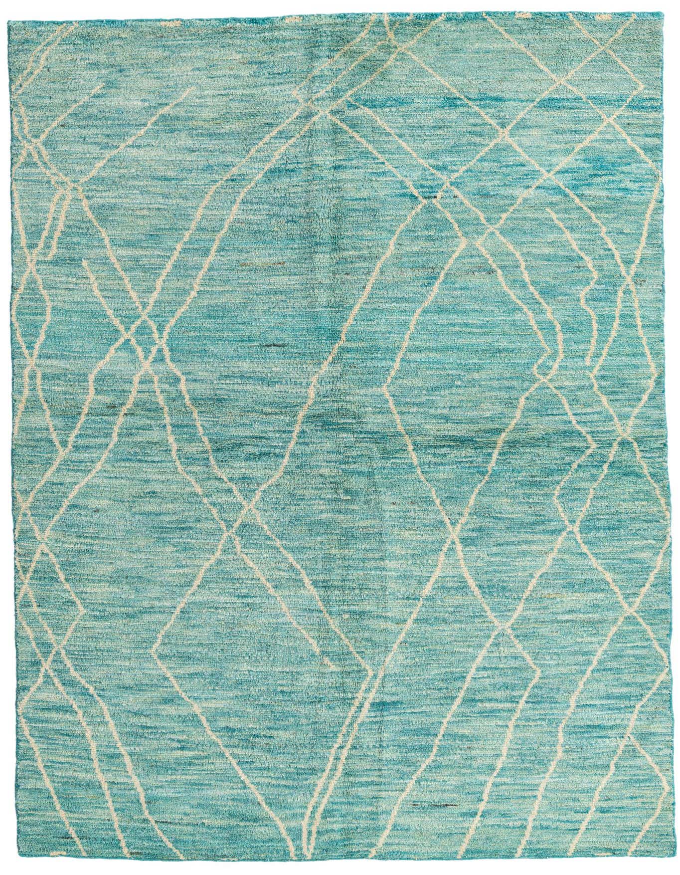 A 6x9 rectangular shag rug in varying shades of green with an abstract tribal diamond pattern in cream.