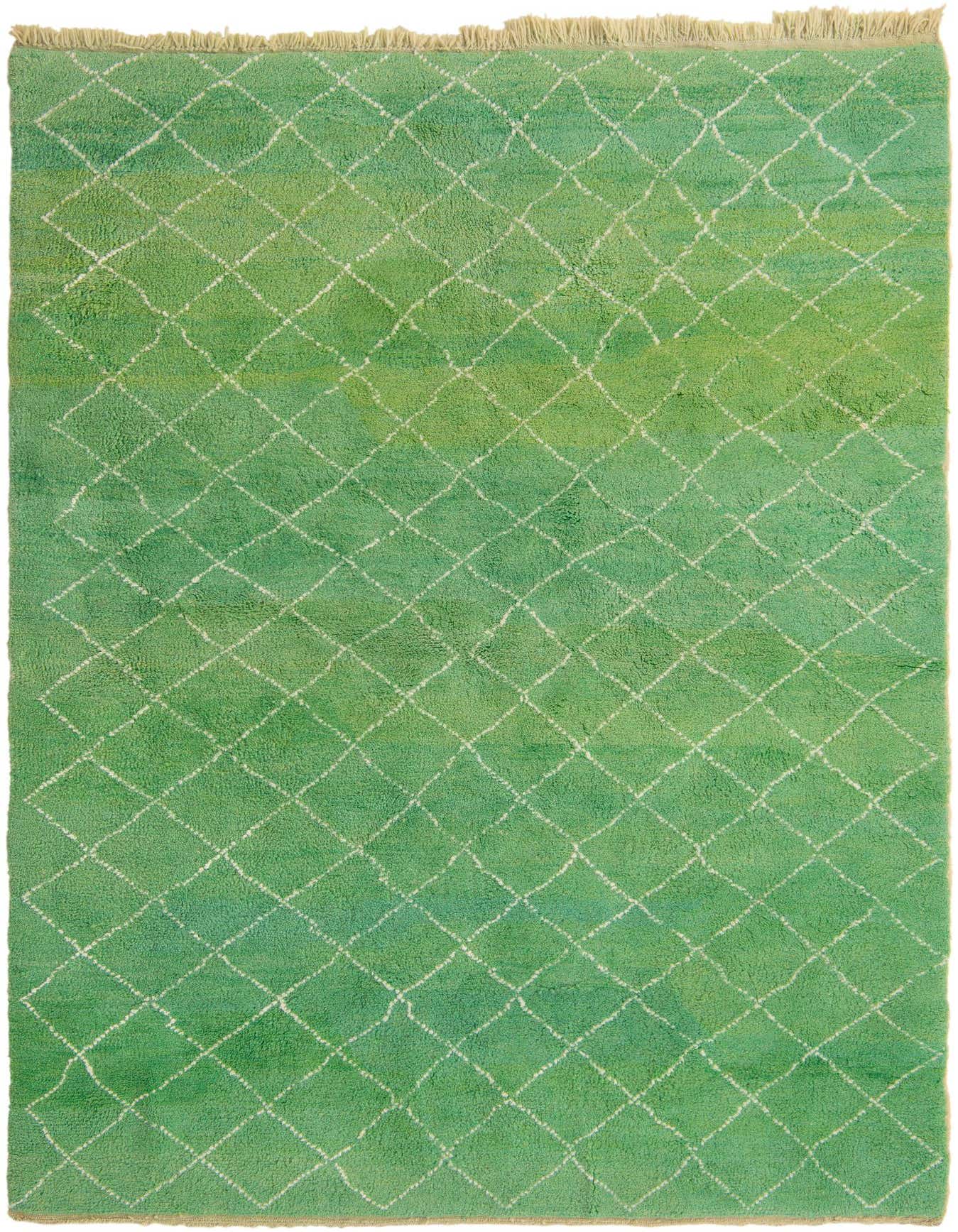 A 7x10 rectangular shag rug in varying shades of green with an off-white tribal diamond pattern and fringed edges.