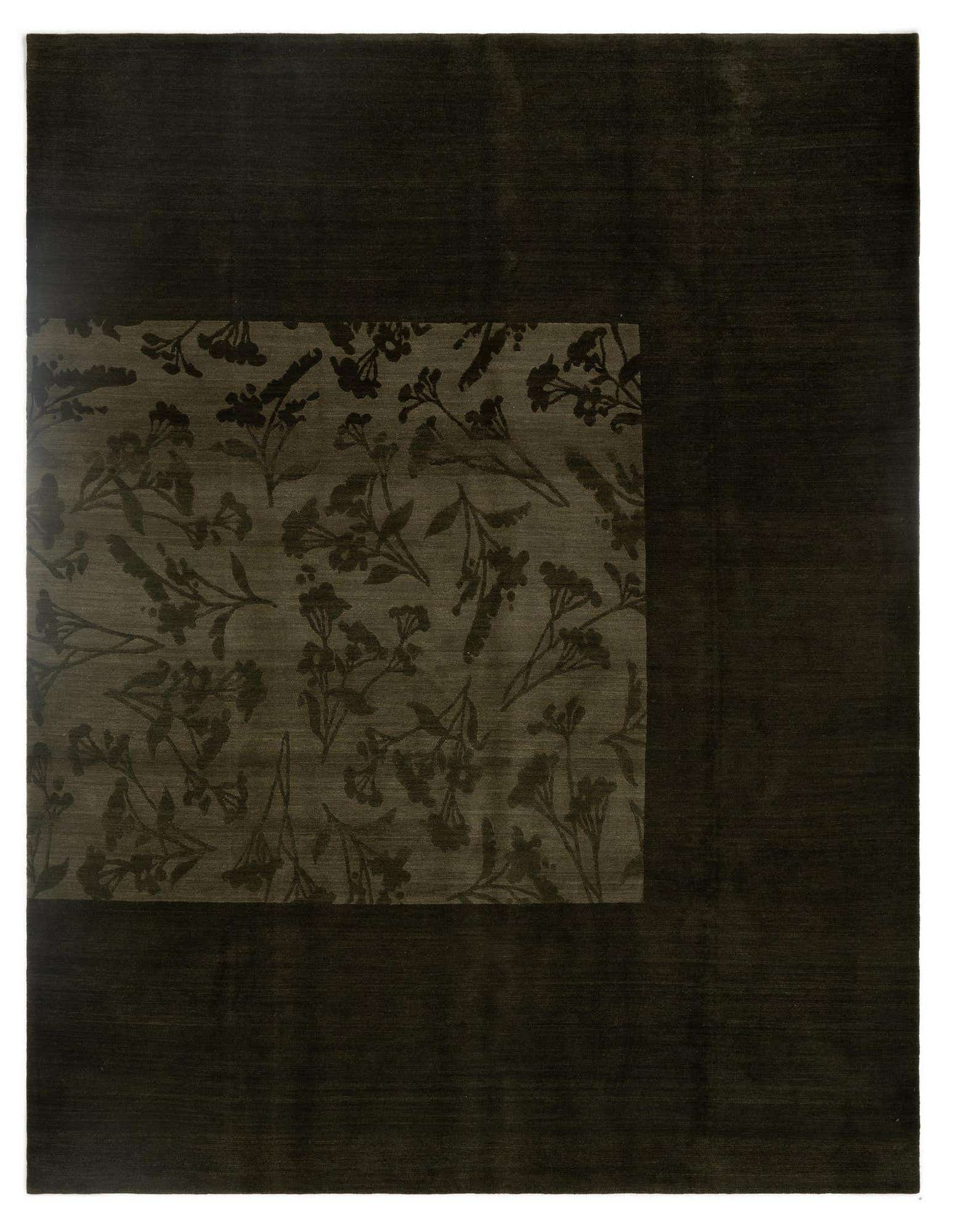An 8x10 rectangular Odegard rug featuring a dark green field with a lighter green Persian floral pattern in one corner.