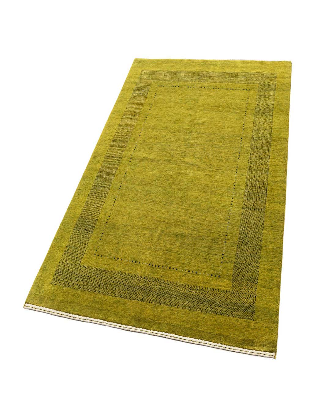 A 4x6 rectangular green wool area rug with a subtle dark green border and dot pattern, suitable for various indoor rooms.