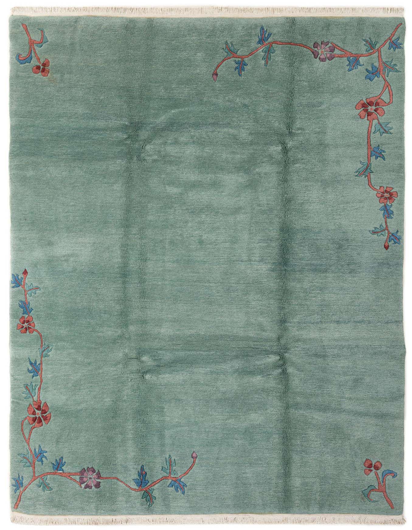 A 7x10 rectangular green wool rug with a medium pile, featuring an oriental floral vine pattern in red and blue along the edges.