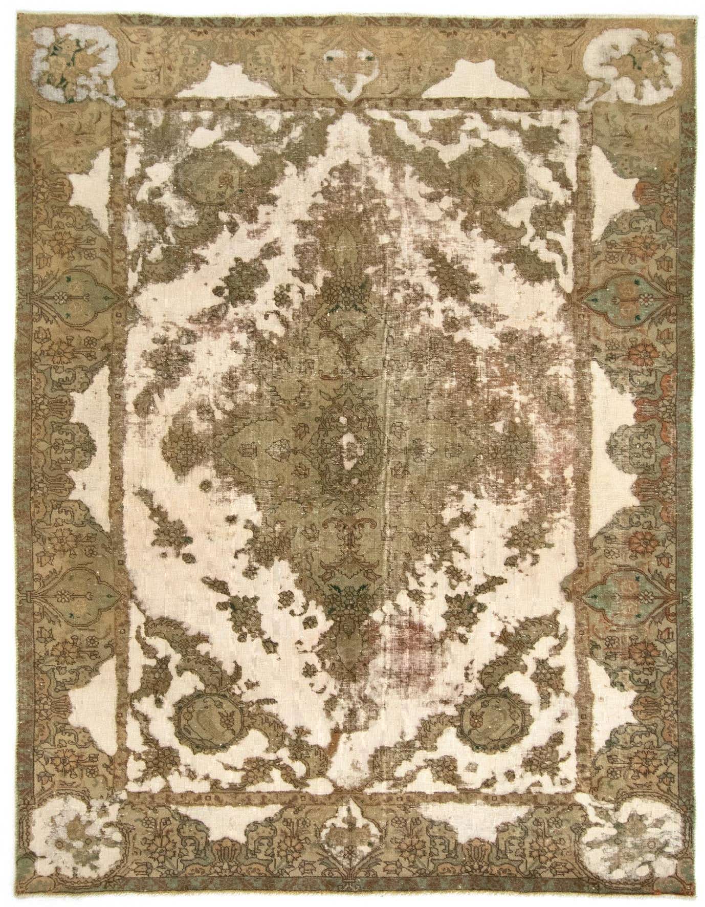 A 7x10 rectangular Vintage Royal rug with a distressed Persian pattern in shades of green and cream, showcasing its handmade wool texture.
