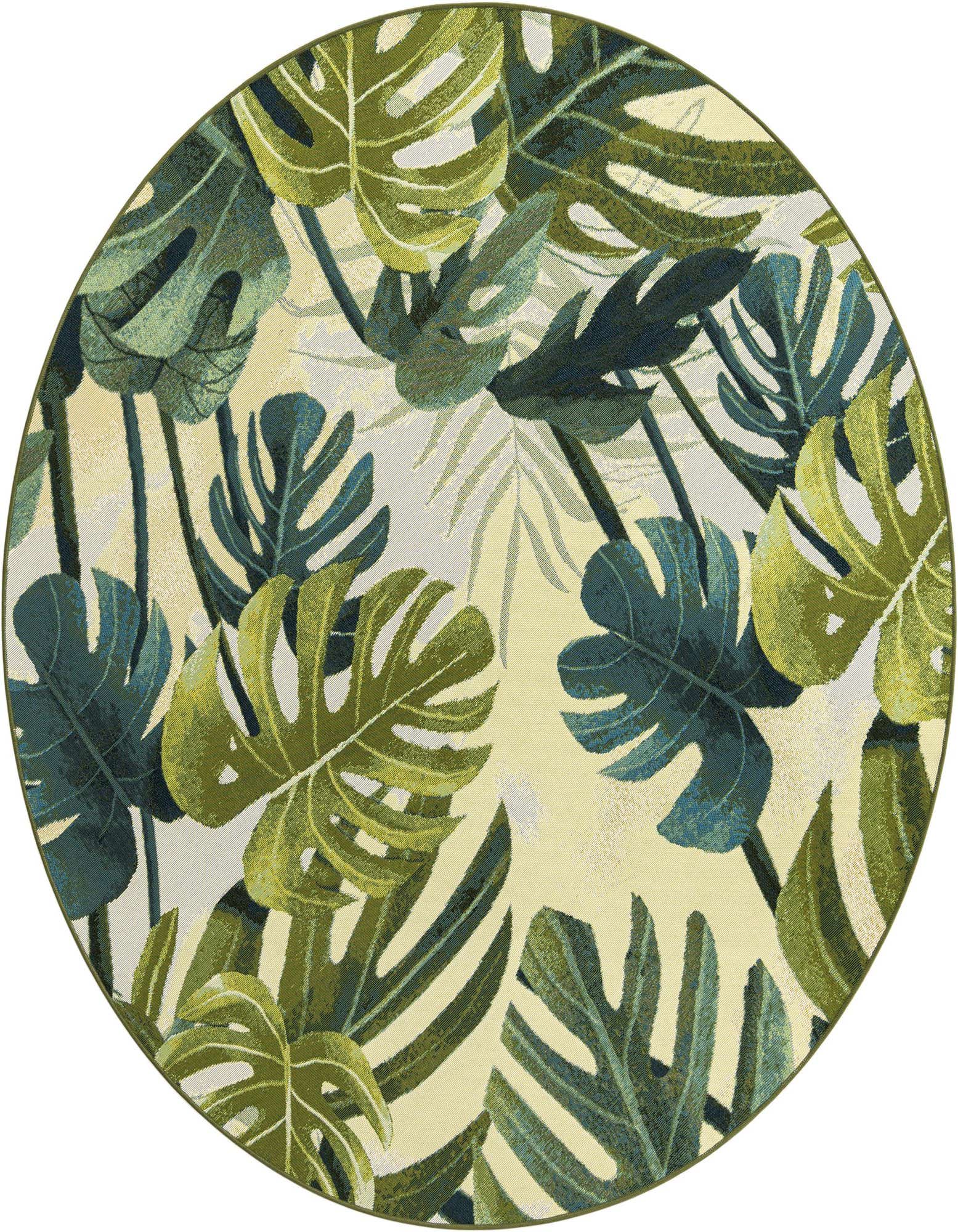 A 7' round green botanical rug with large monstera and palm leaves on a light background, suitable for indoor or outdoor use.