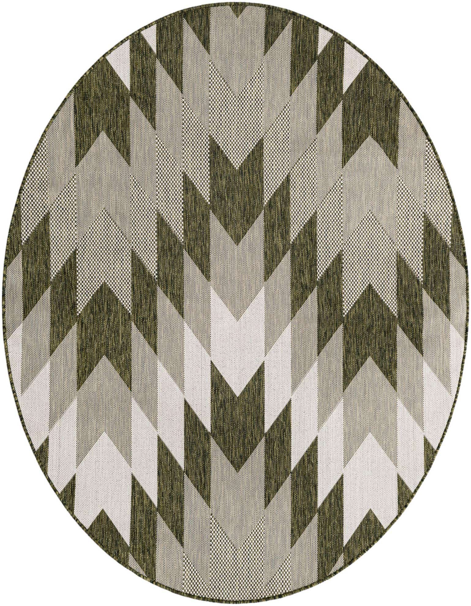 A round green tribal rug featuring a modern geometric chevron pattern in varying shades of green, gray, and off-white.