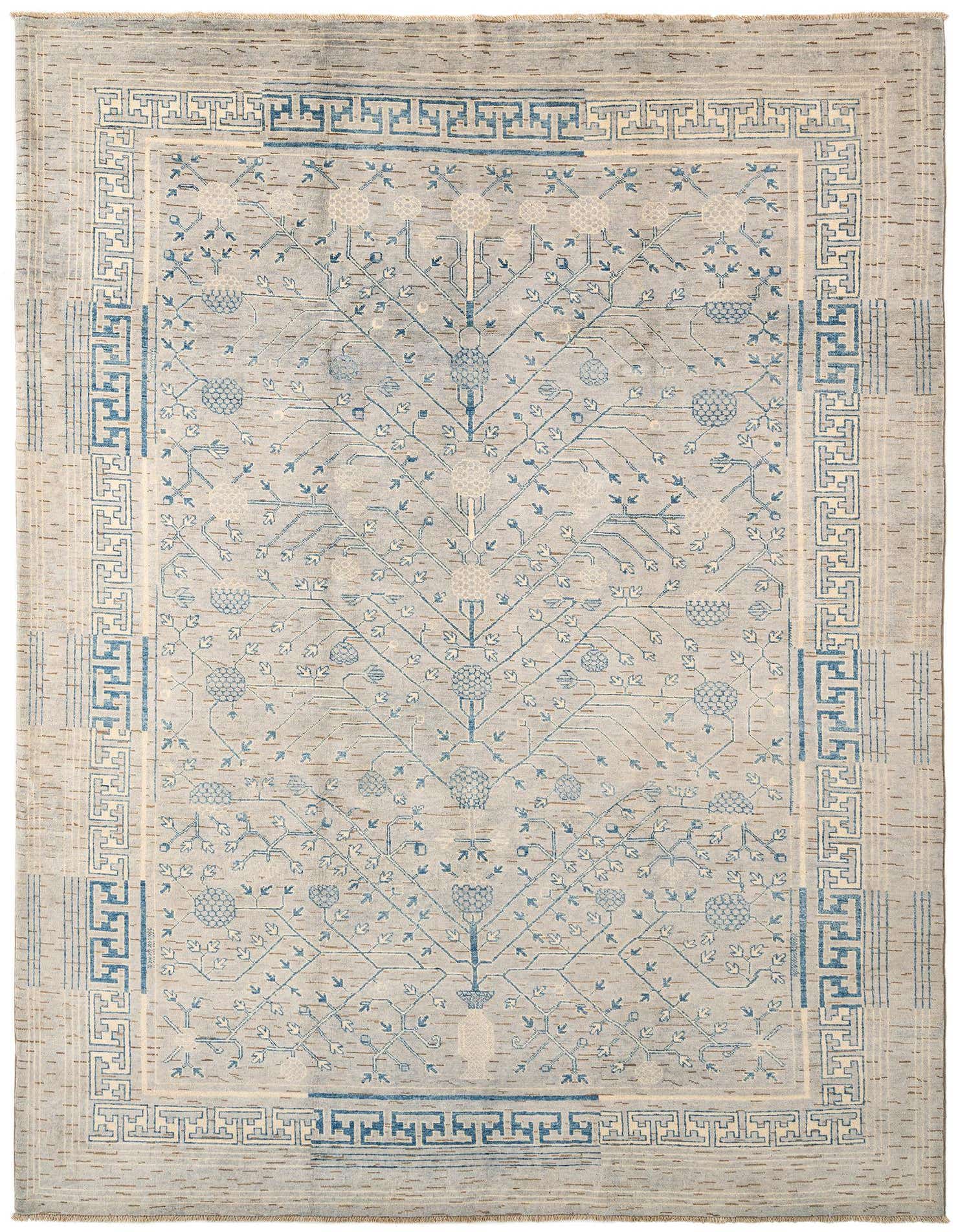 A 6x9 rectangular grey wool rug with a detailed blue tree-of-life pattern and a geometric border.