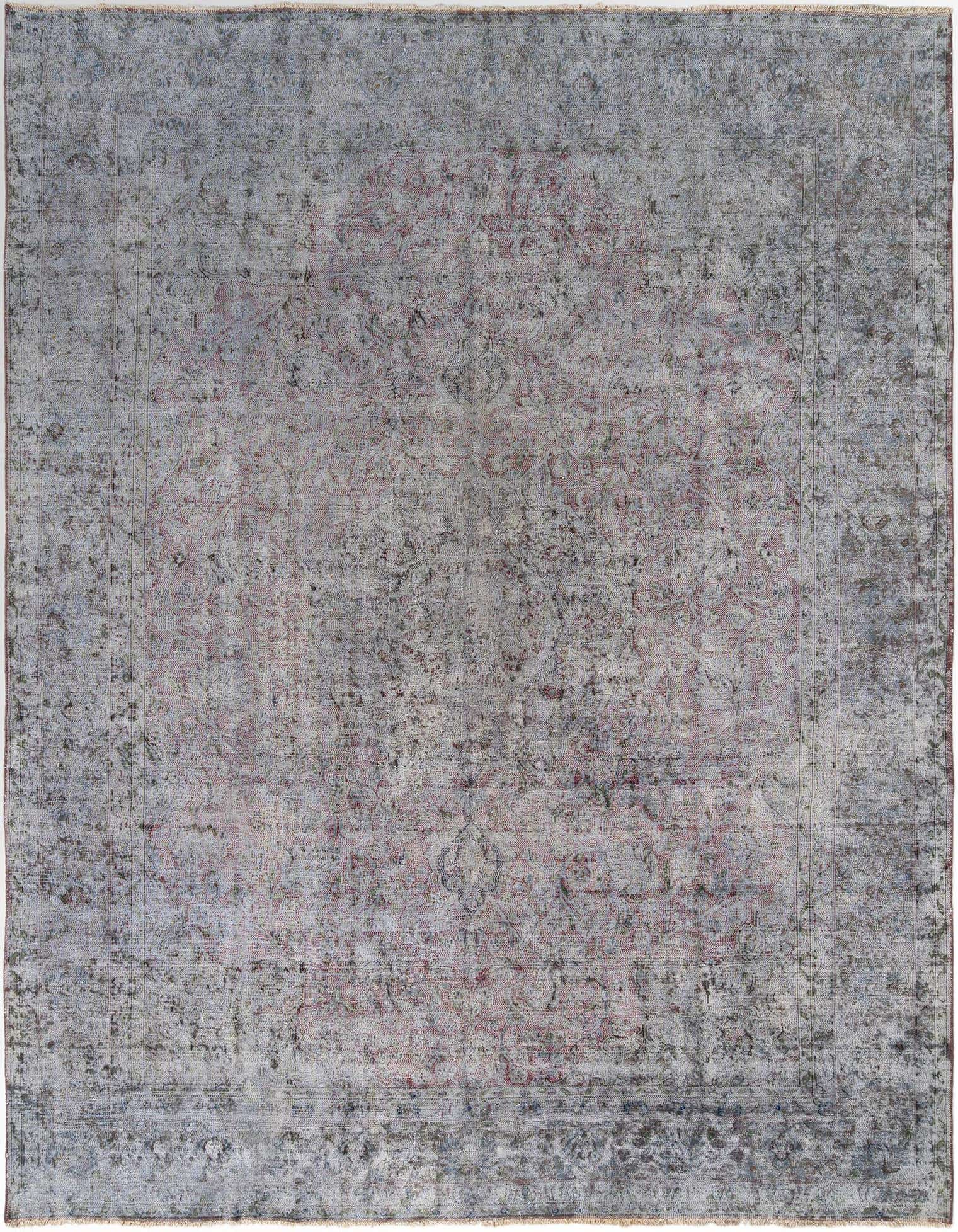 A 10x13 rectangular grey Persian wool rug with a distressed, faded traditional pattern in a living room setting.