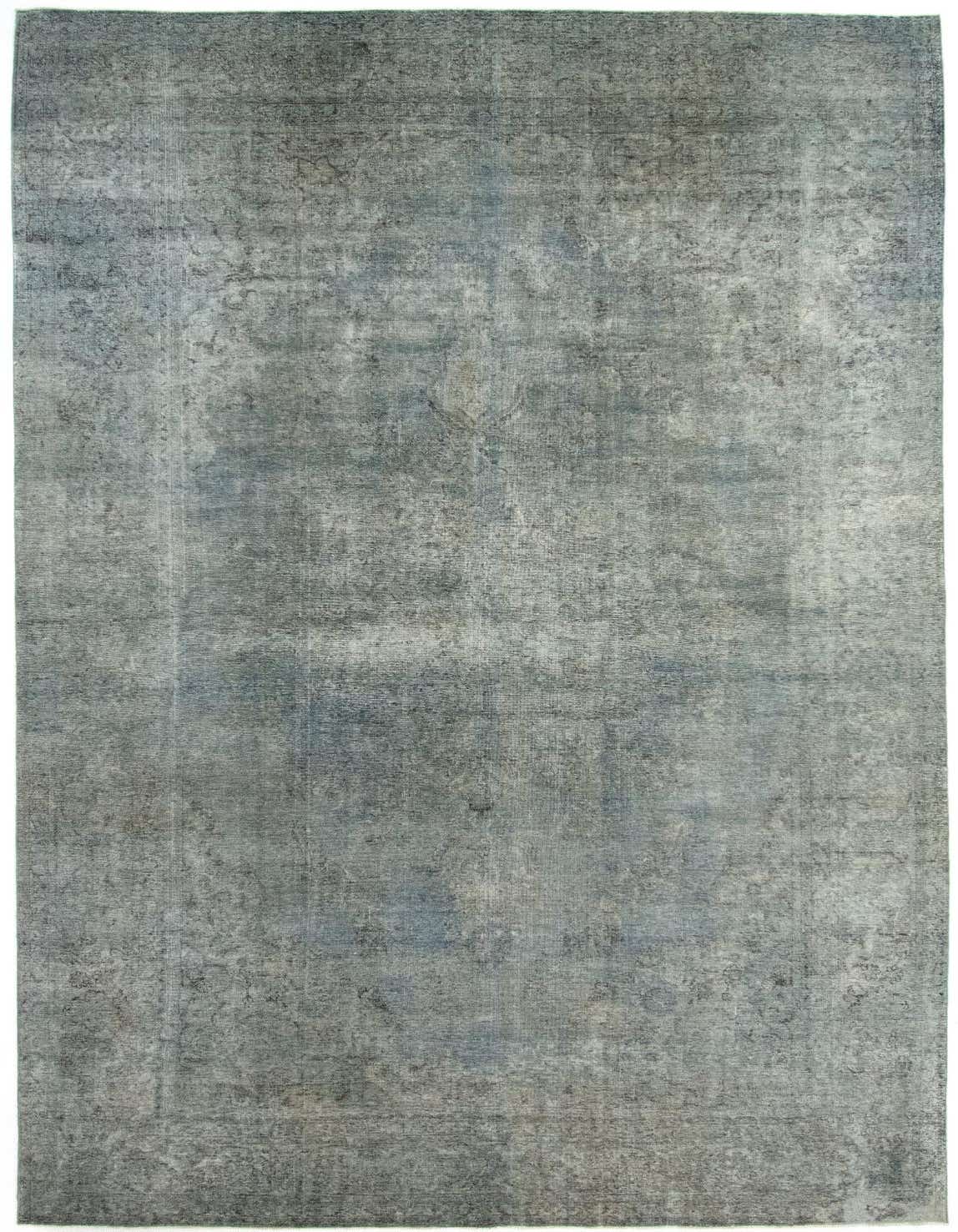 Oversized rectangular grey Persian wool rug with a distressed, faded traditional pattern, suitable for a living room.