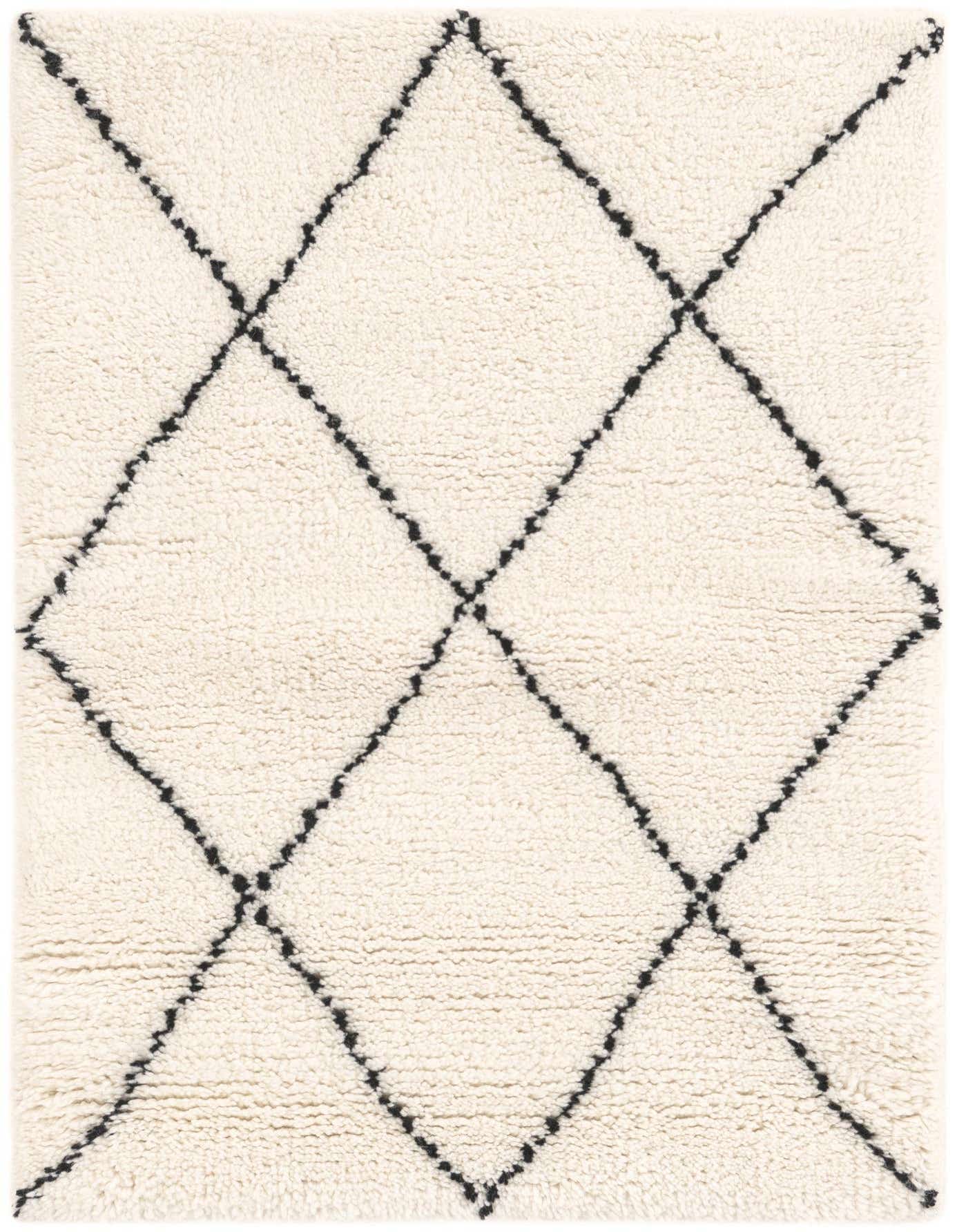 A rectangular 2x3 Safiya Moroccan Wool rug with a cream background and a black tribal diamond pattern.