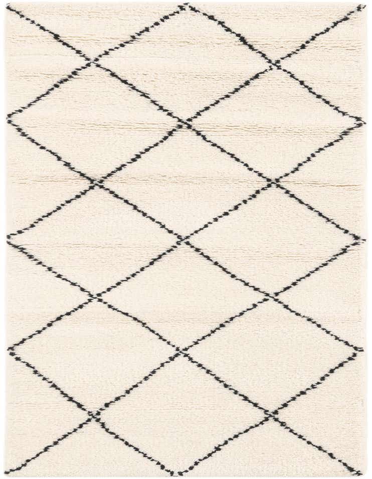 A 6 ft runner rug with a cream background and a bold black tribal diamond pattern, showcasing its textured medium pile.