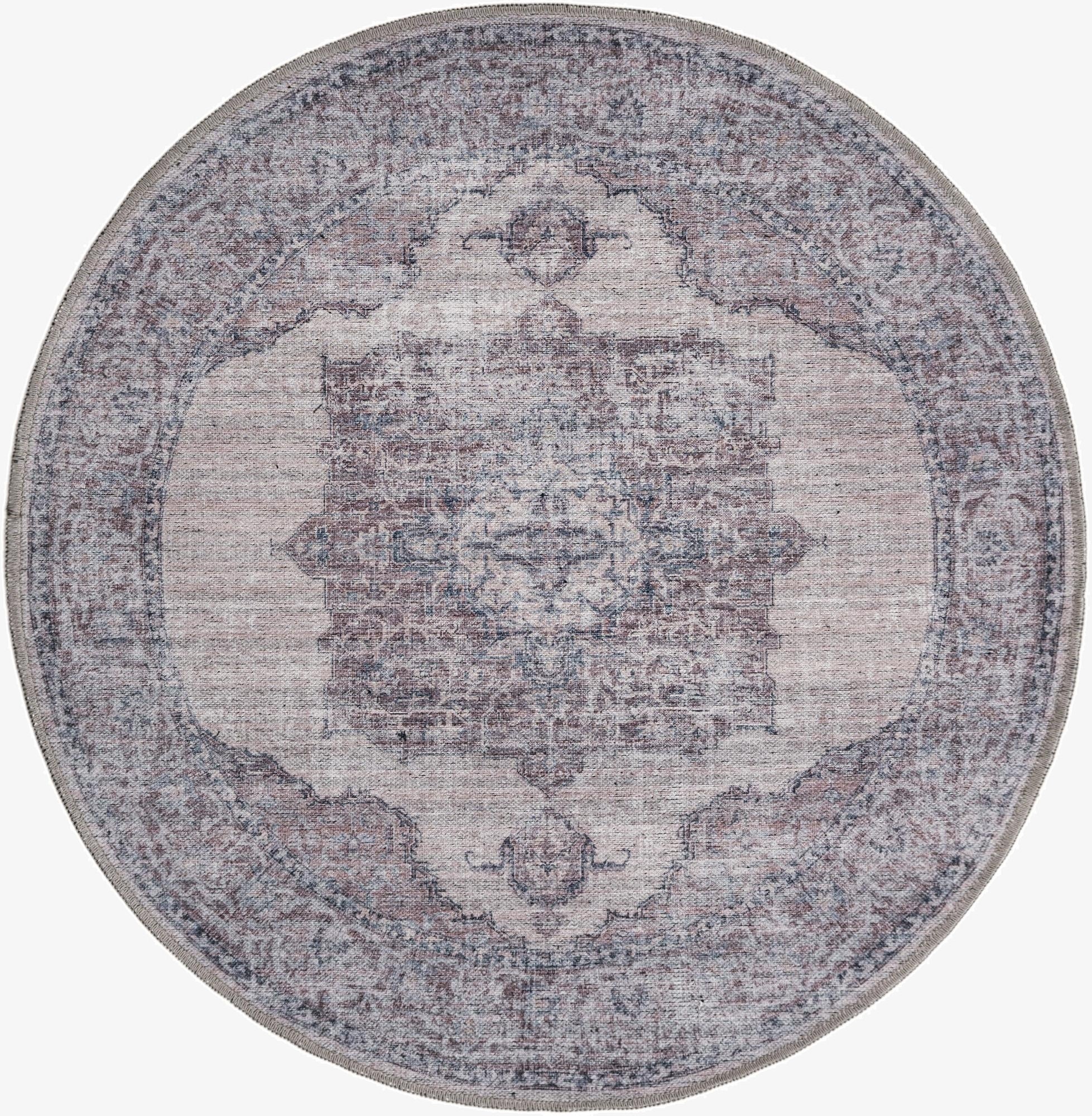 A 4' round ivory and gray traditional medallion rug with a vintage distressed look, suitable for an indoor patio.