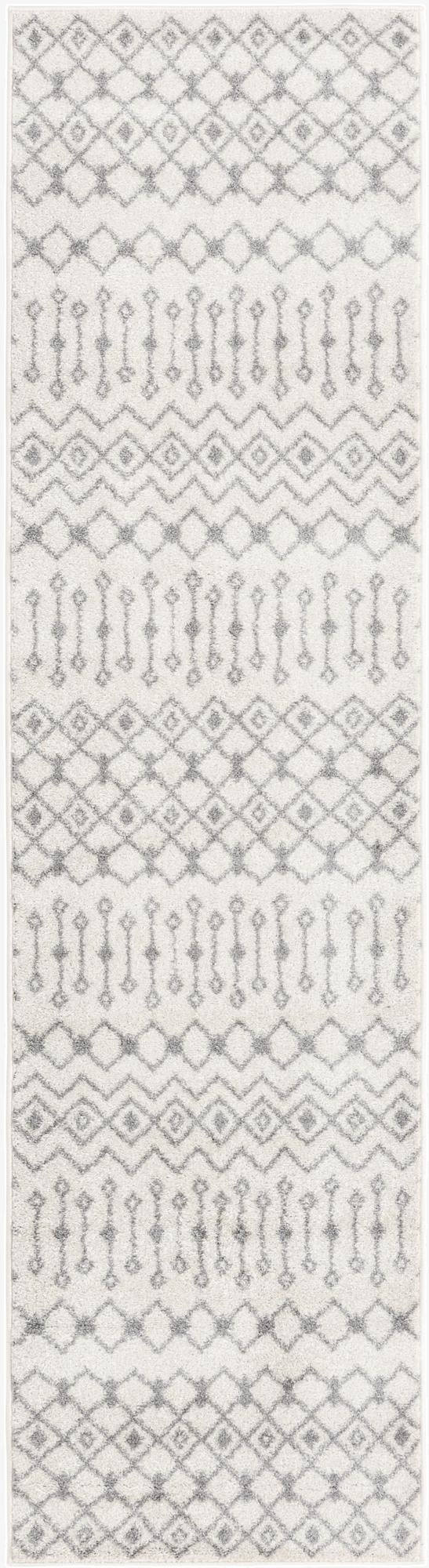 A 10 ft runner rug in ivory and gray, featuring a plush, medium pile with a modern tribal trellis pattern.