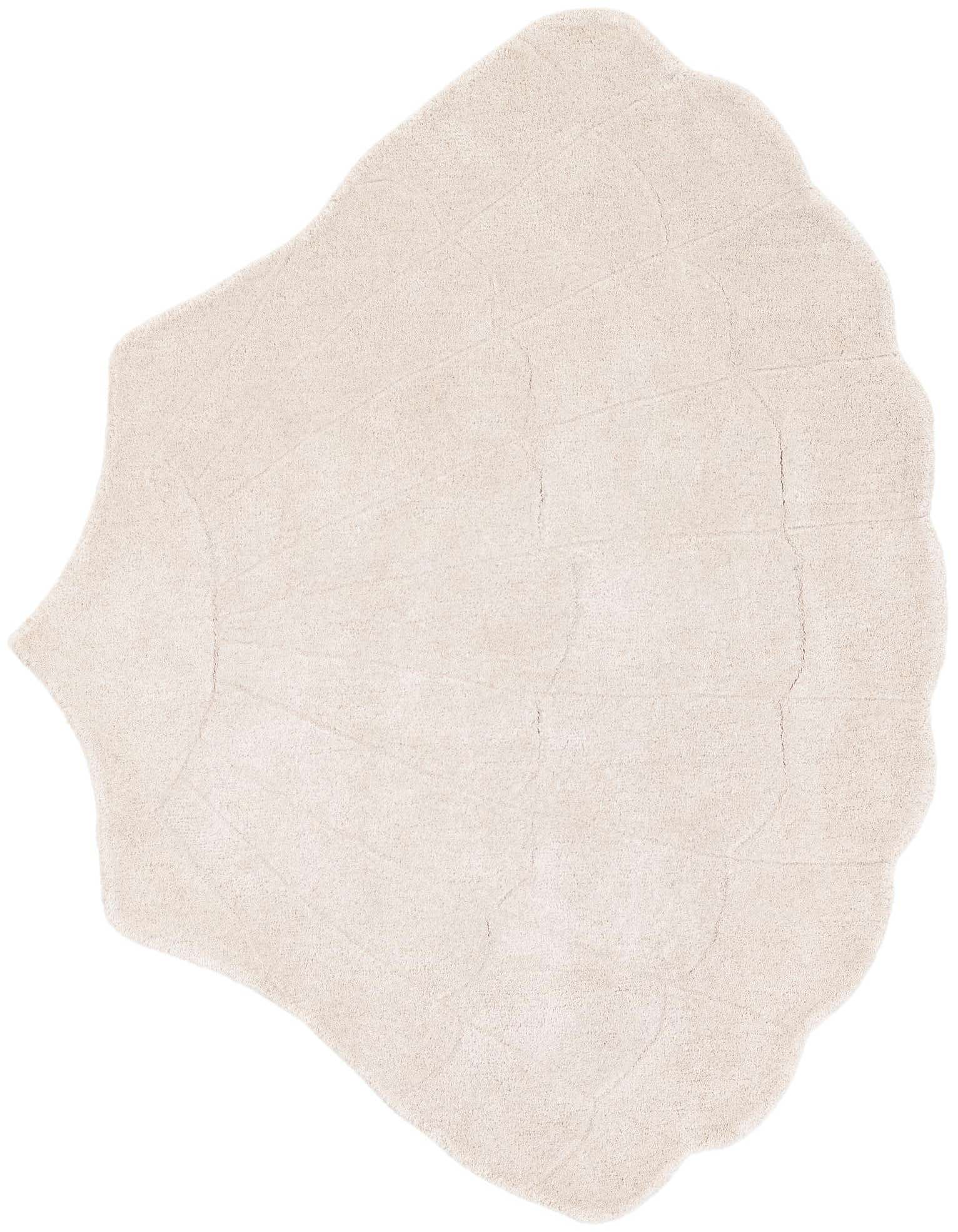 A 4' 1 x 5' 3 freeform ivory and cream wool rug with a high, textured pile, resembling a large seashell.