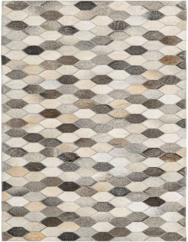 A 6 ft runner rug featuring a modern abstract pattern of hexagonal cowhide patches in ivories, creams, grays, and whites.