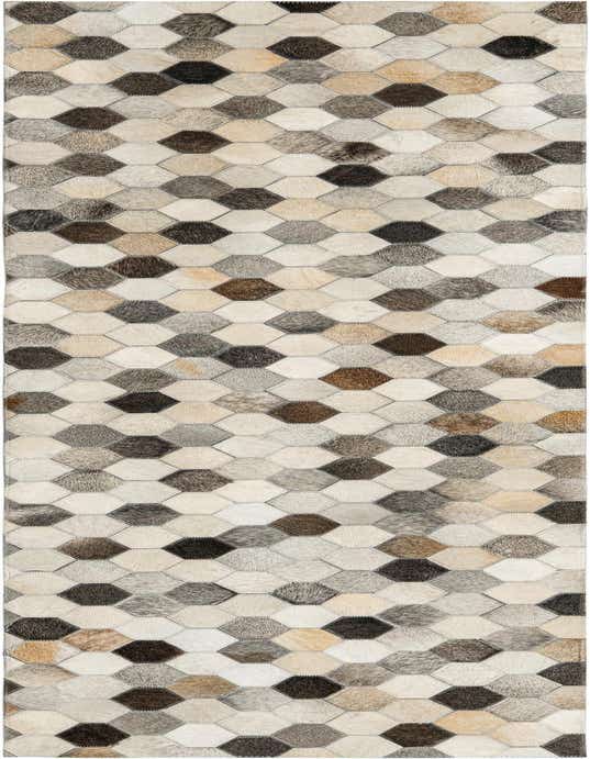 An 8 ft runner rug featuring a modern, abstract honeycomb pattern made from patched cowhide in shades of ivory, cream, gray, and white.