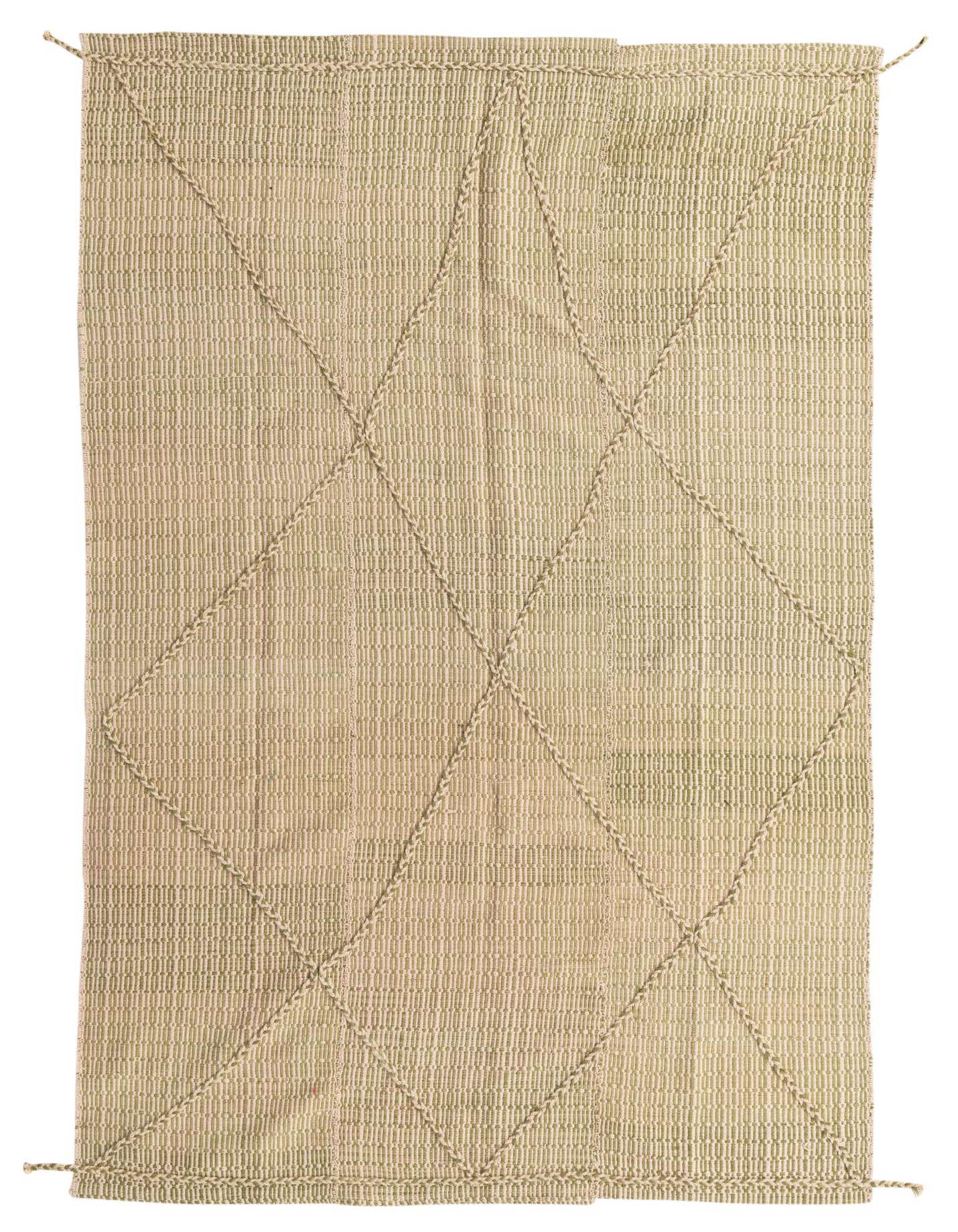 A 6x9 rectangular ivory shag rug with a subtle green tint and a tribal diamond pattern made from braided wool.