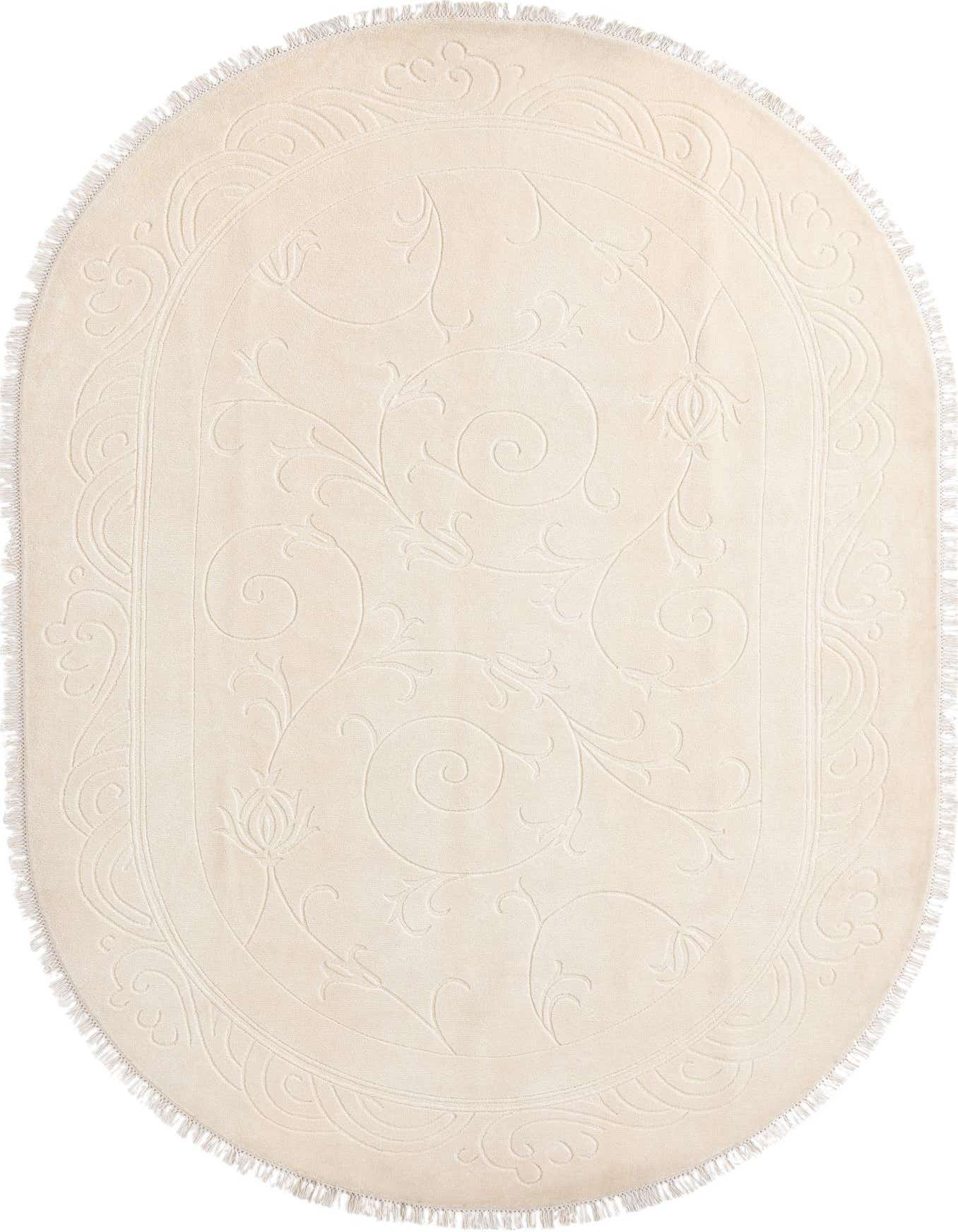 An oval 6' 6 x 9' 8 ivory wool rug with a subtle embossed modern oriental pattern and fringed edges.
