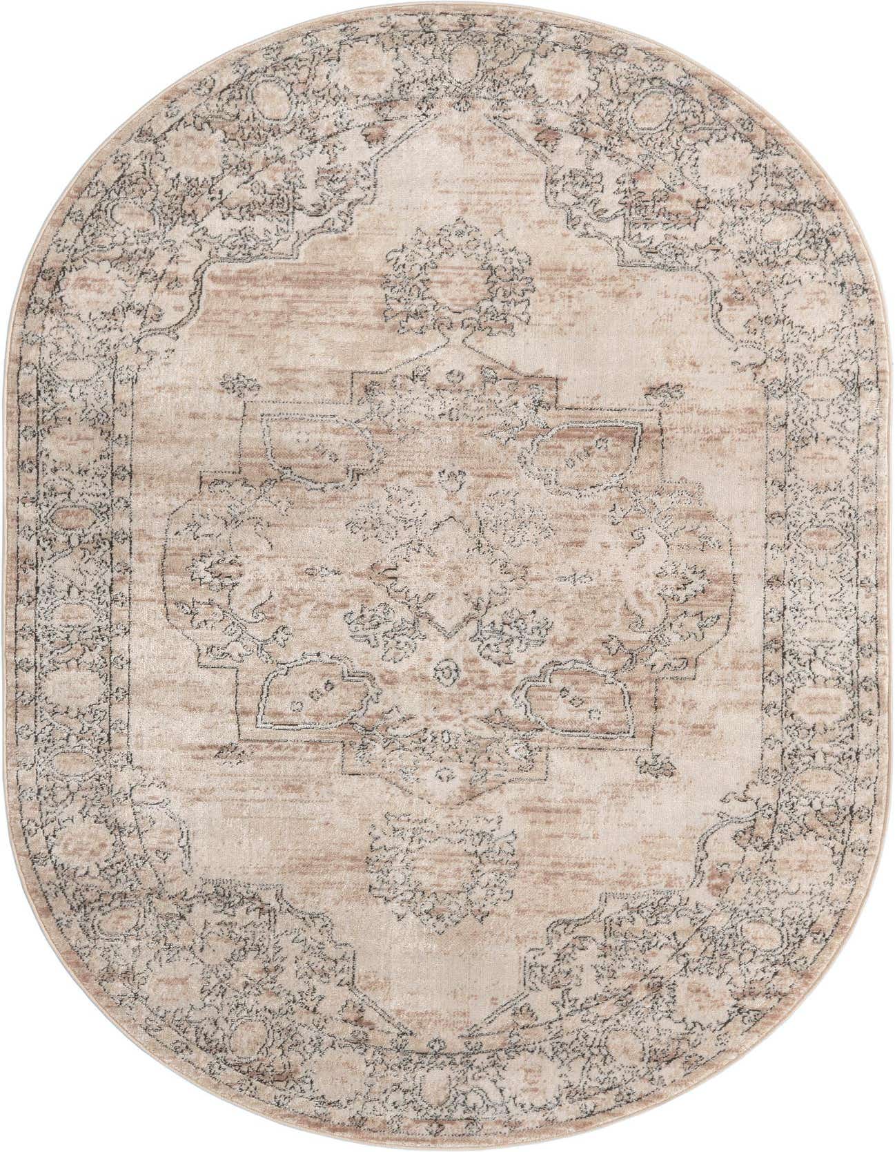 An oval 5'3" x 8'0" ivory and cream area rug with a distressed traditional medallion pattern.