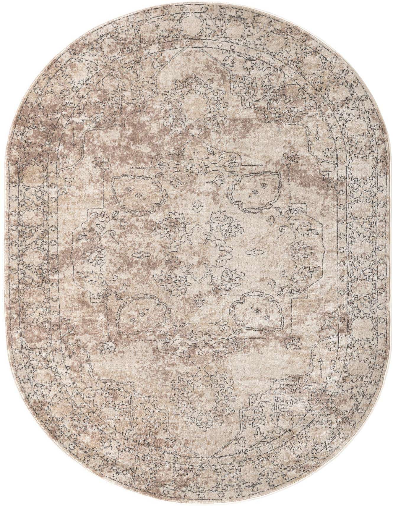 An oval 6'1" x 9'0" ivory and cream area rug with a distressed medallion and transitional floral pattern.
