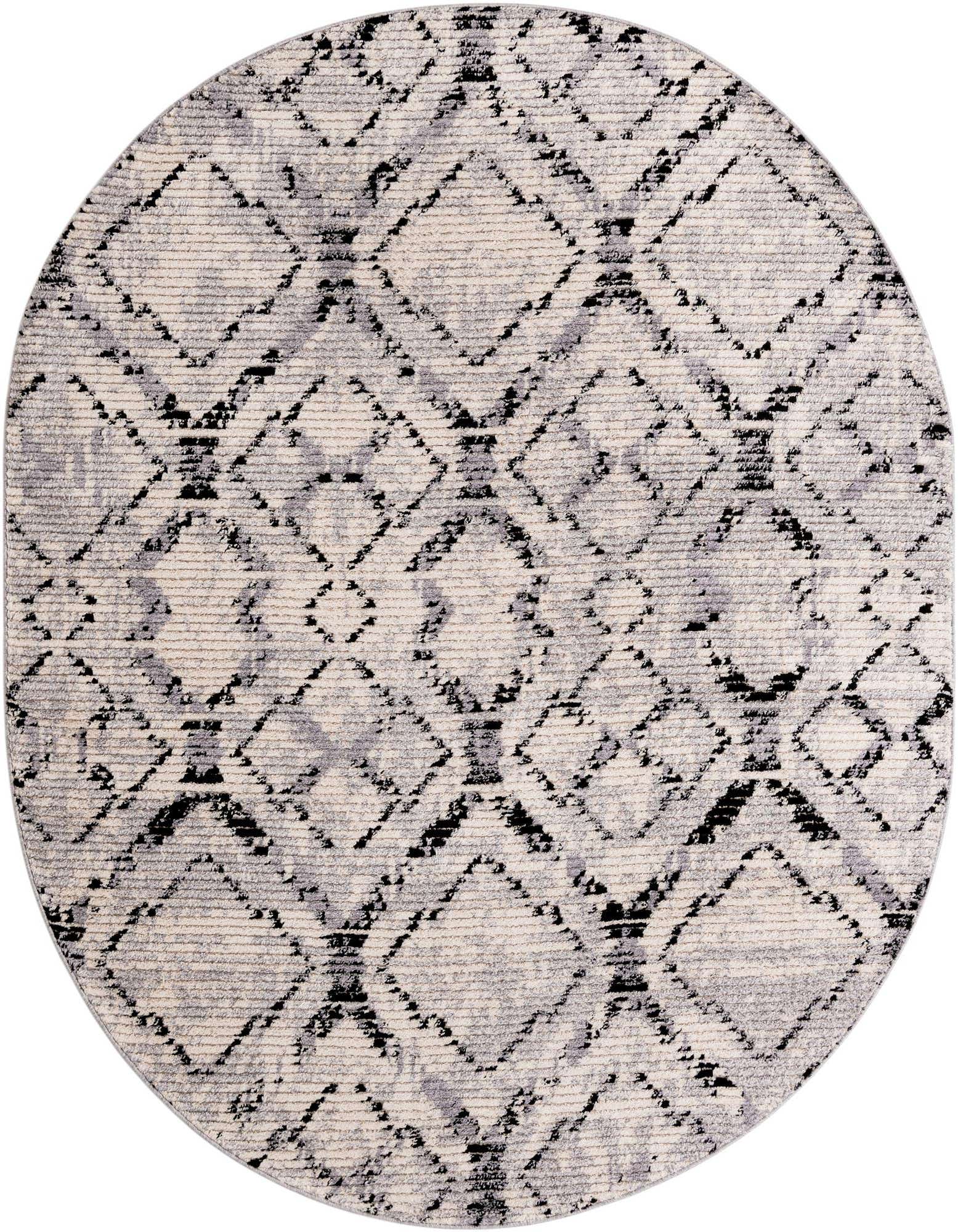An 8' x 10' oval ivory and black modern shag rug with a distressed geometric diamond pattern.