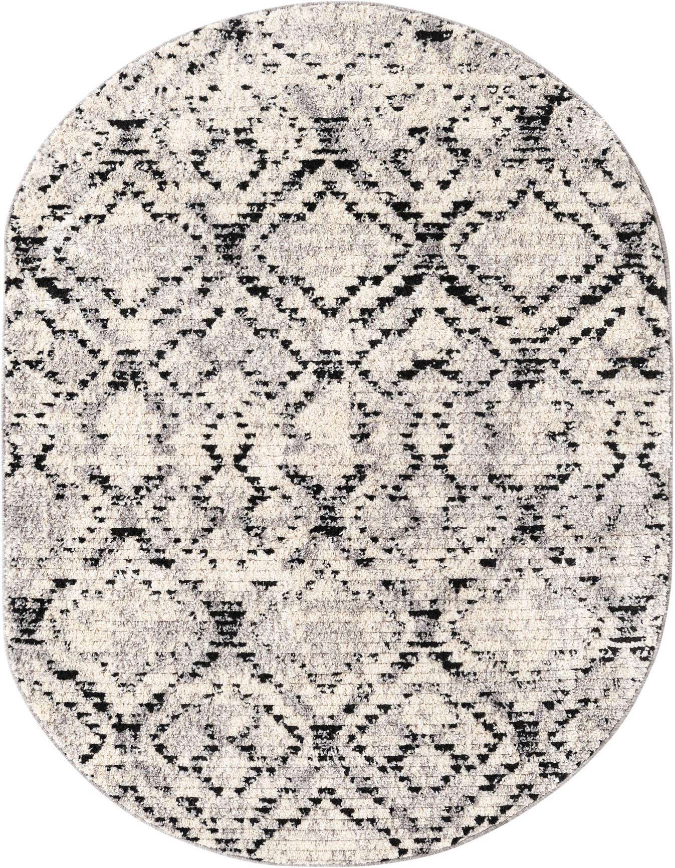 An oval 4' x 6' ivory and black modern shag rug with a distressed geometric stripe pattern.