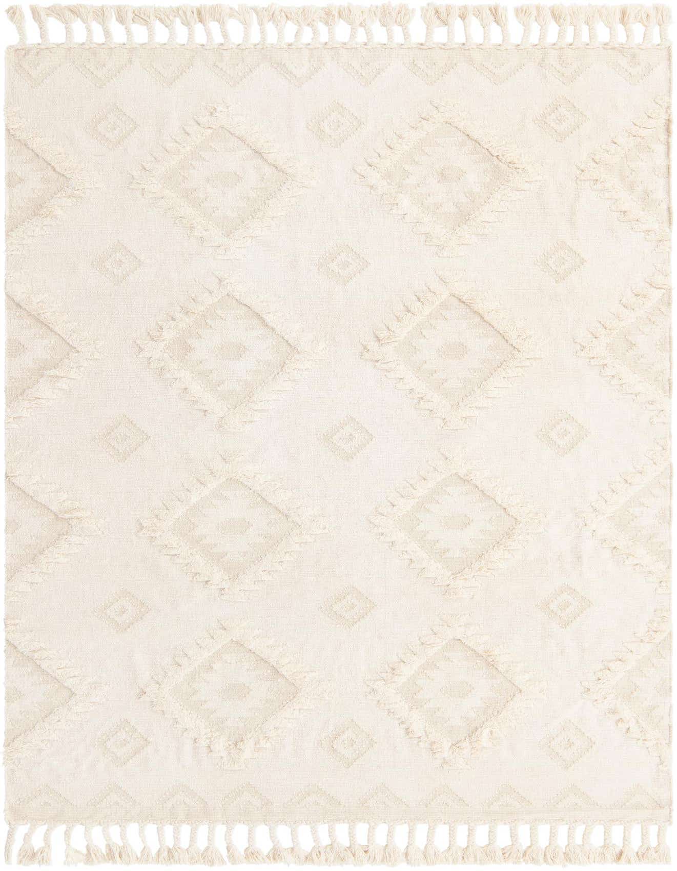 A 7x10 rectangular ivory wool shag rug with a textured Southwestern diamond pattern and decorative tassels.
