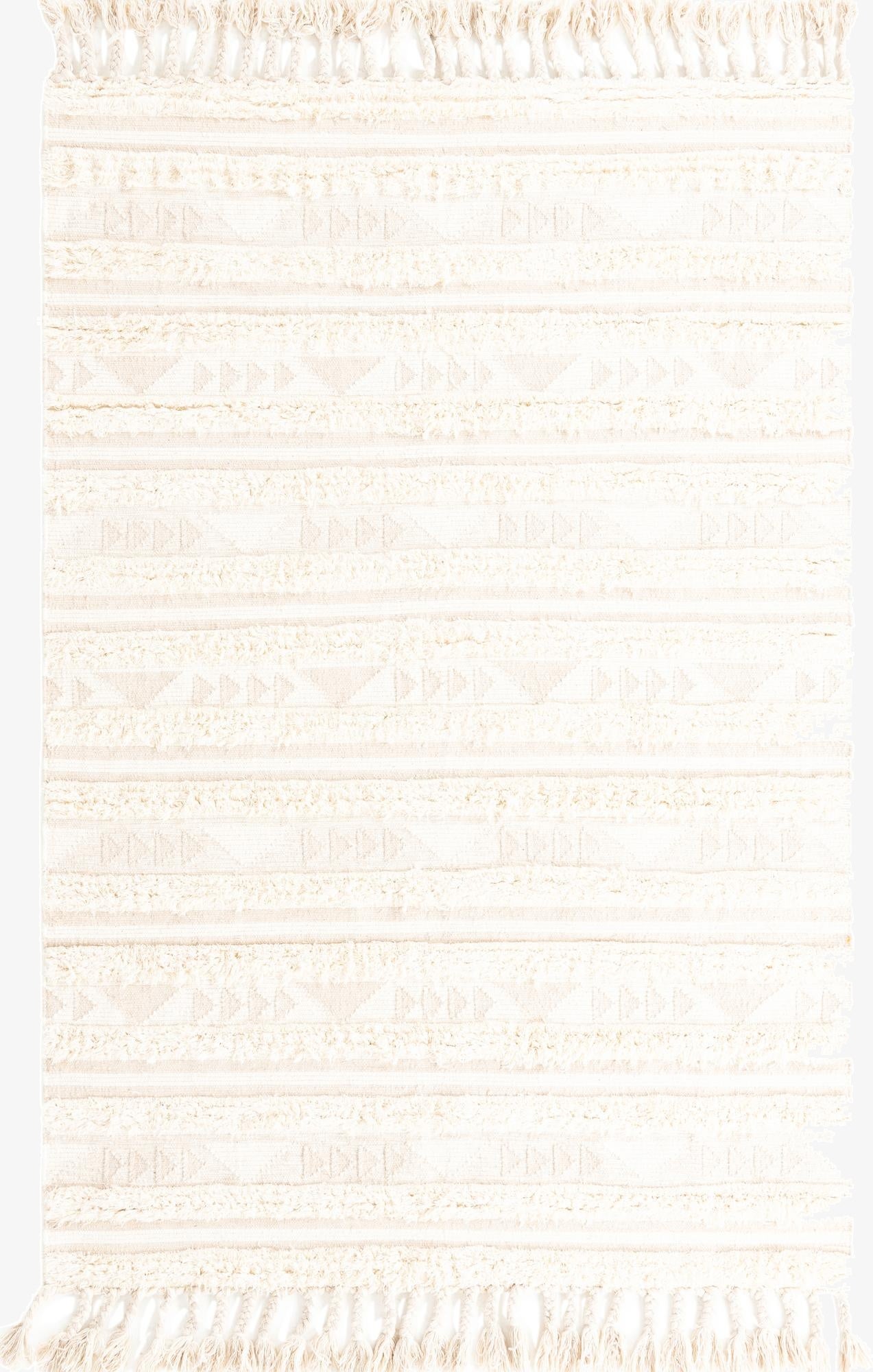 A 6x9 rectangular ivory and cream wool shag rug with tribal geometric patterns and tassels, ideal for a living room.