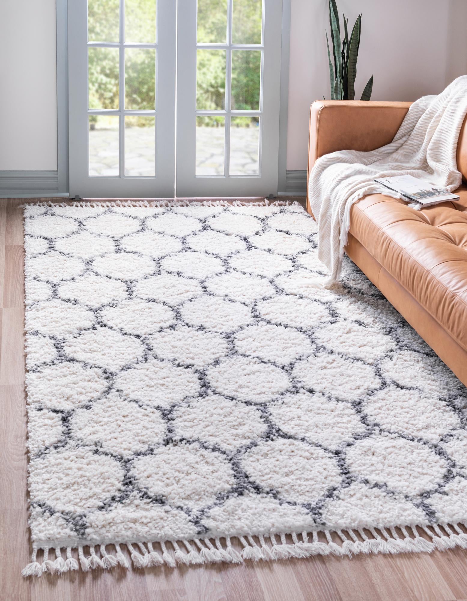 An 8x10 rectangular ivory shag rug with a repeating gray Moroccan trellis pattern, suitable for a living room.