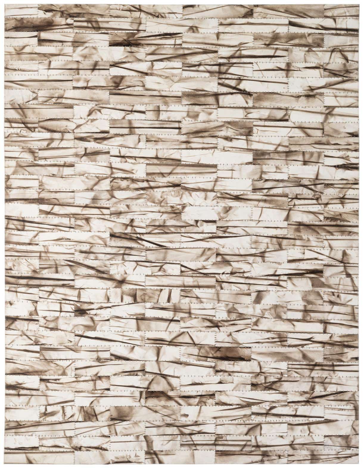 A 5x8 rectangular ivory and cream cowhide rug featuring a modern patchwork design with visible stitching.