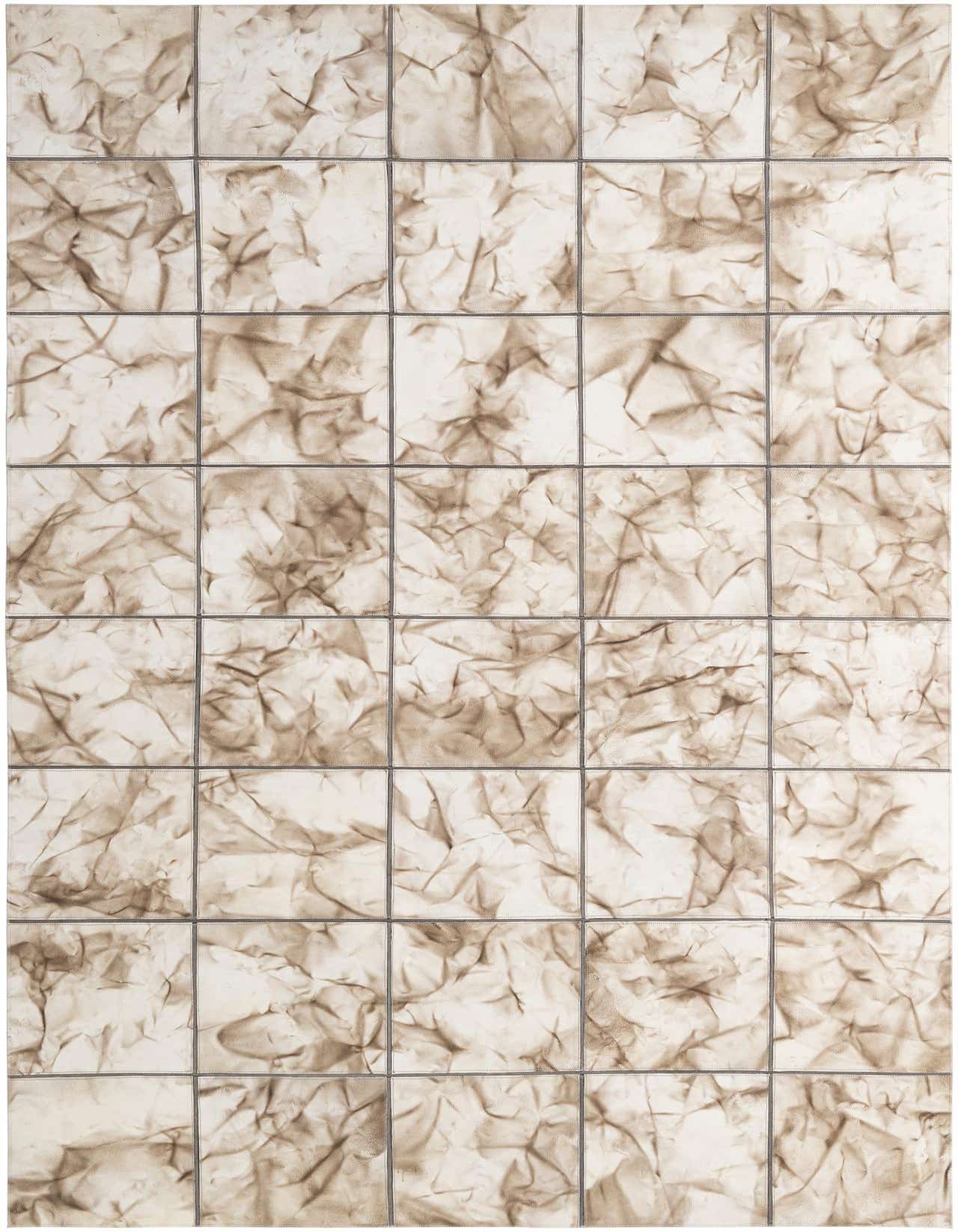 A 5x8 rectangular Cowhide Patchwork rug featuring ivory and cream squares with abstract, crinkled brown patterns, ideal for a modern living room.