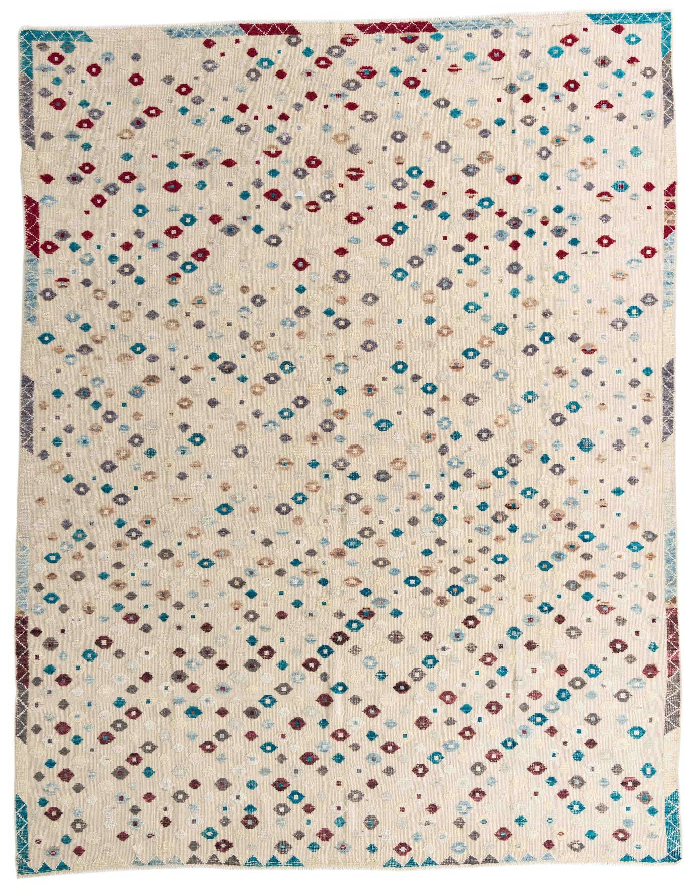 A 10x14 rectangular ivory wool rug with a modern abstract pattern of scattered red, blue, and brown diamond shapes.
