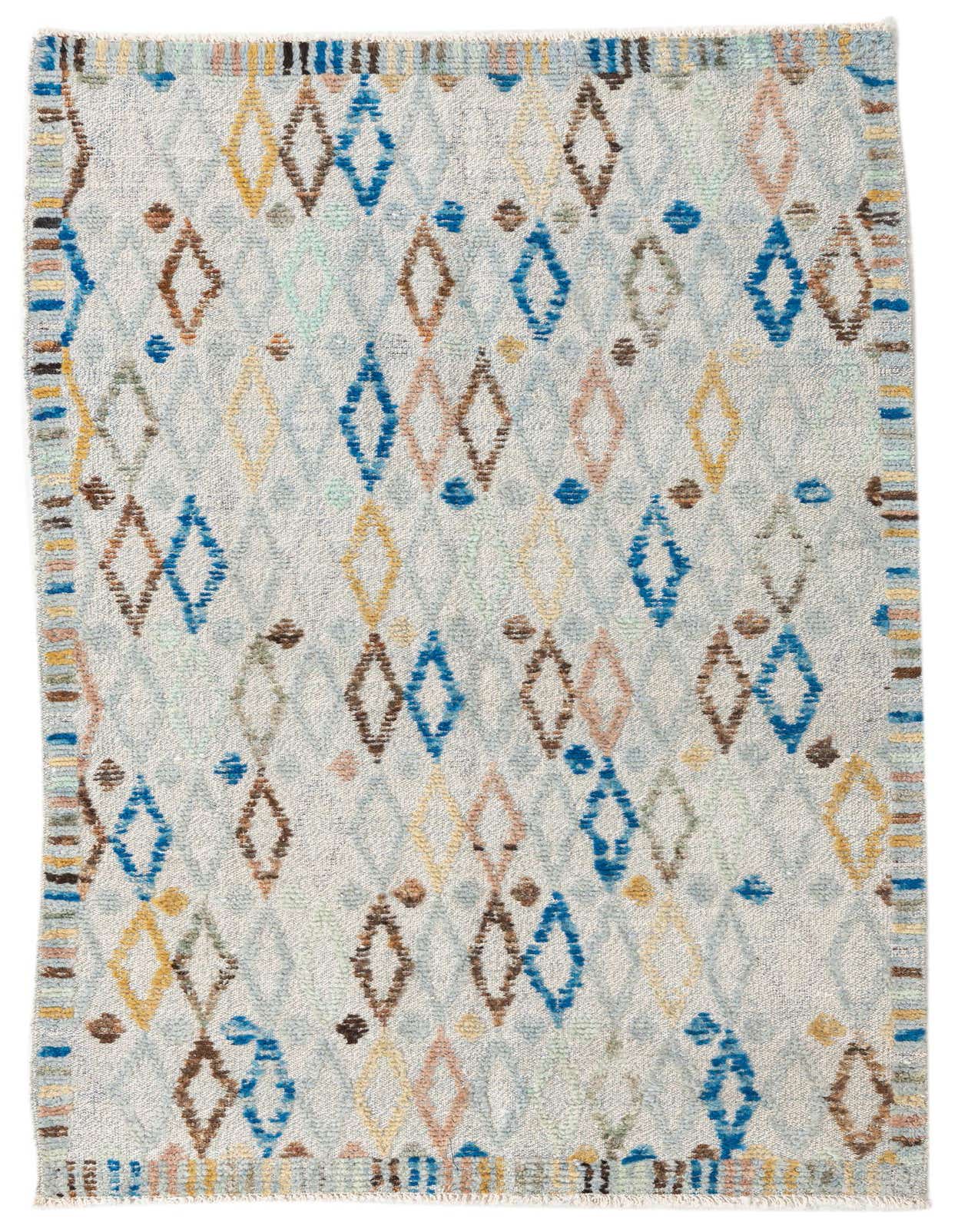 A 4x6 rectangular ivory wool rug with a modern Oriental pattern of colorful diamond shapes in blue, brown, yellow, and pink.