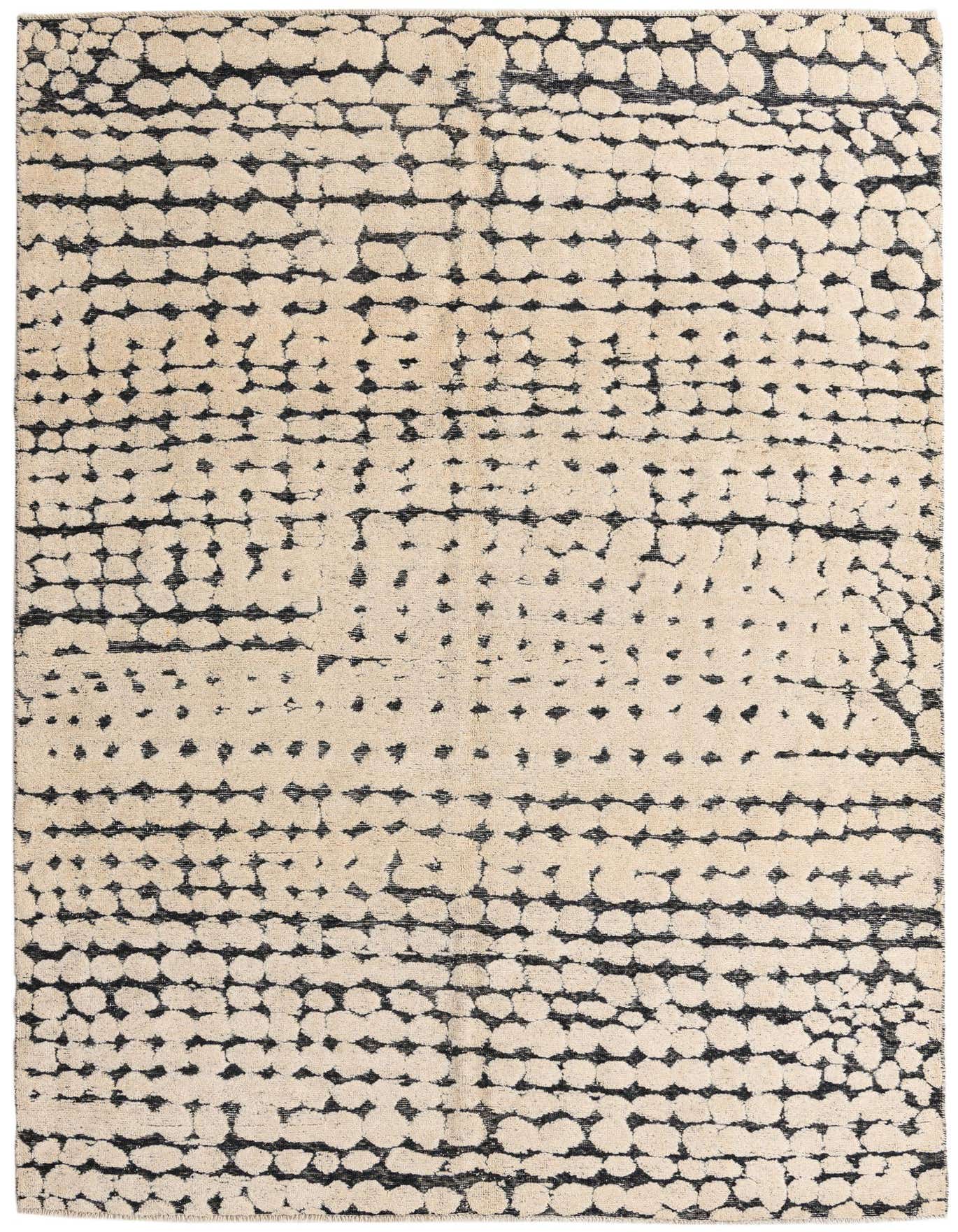 A 7x10 rectangular ivory and black modern abstract wool rug with a textured dotted pattern, ideal for a living room.